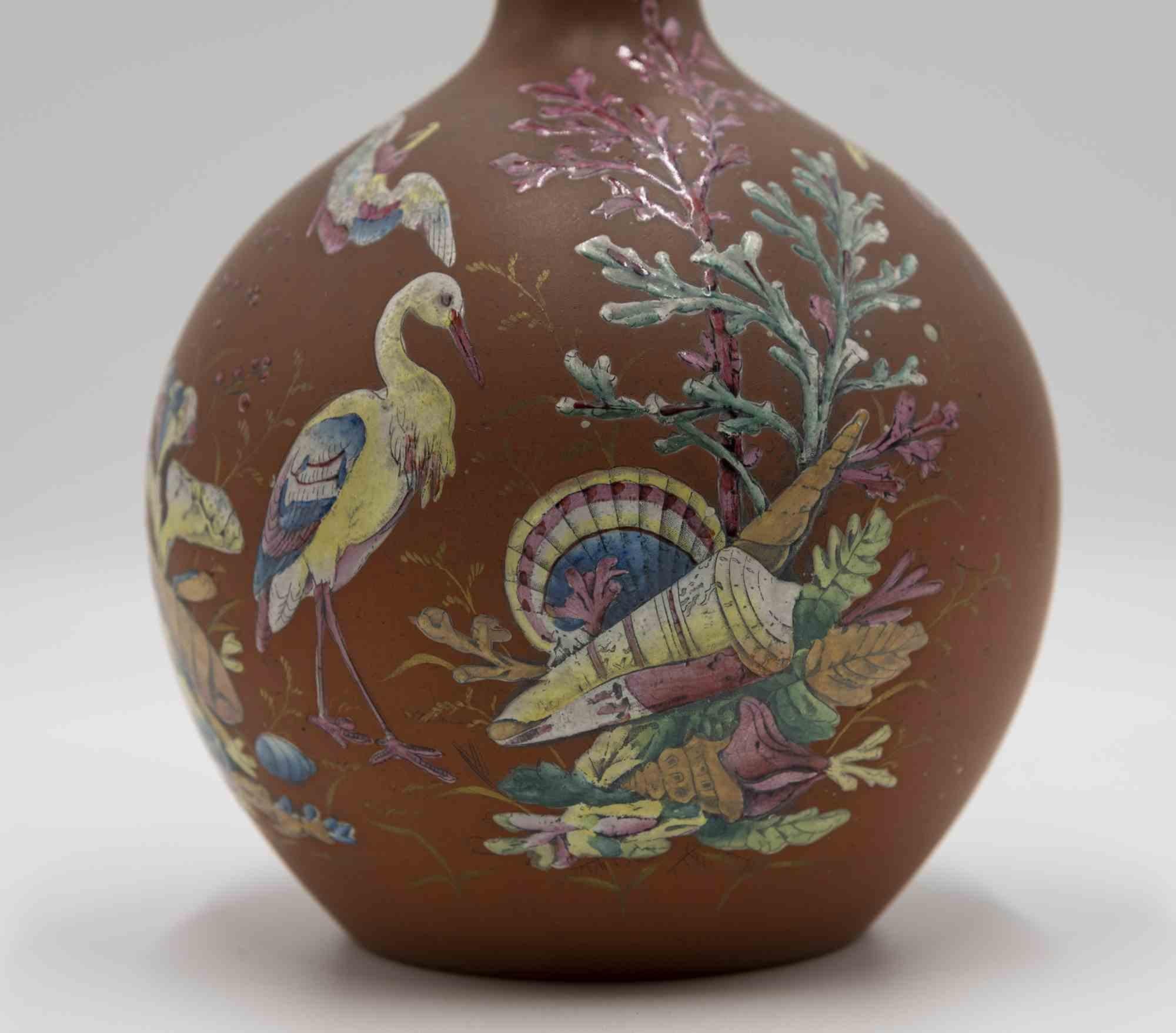 Bottle with natural decorations is a terracotta bottle realized in the early 20th century.

The bottle is decorated with images of animals and plants and it has a stopper.

Good condition.