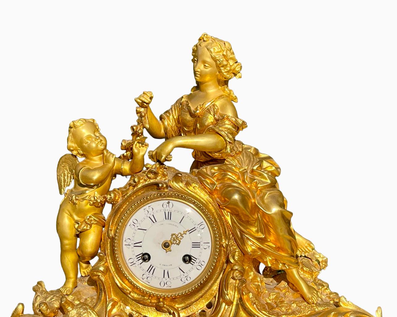 Gilt bronze clock representing Love (Cupid) and Psyche with an enamel dial in the center signed Bouchard à Beaune. Very beautiful original gilding and good general condition.
Please note - a needle is missing on the dial.

Dimensions
Height