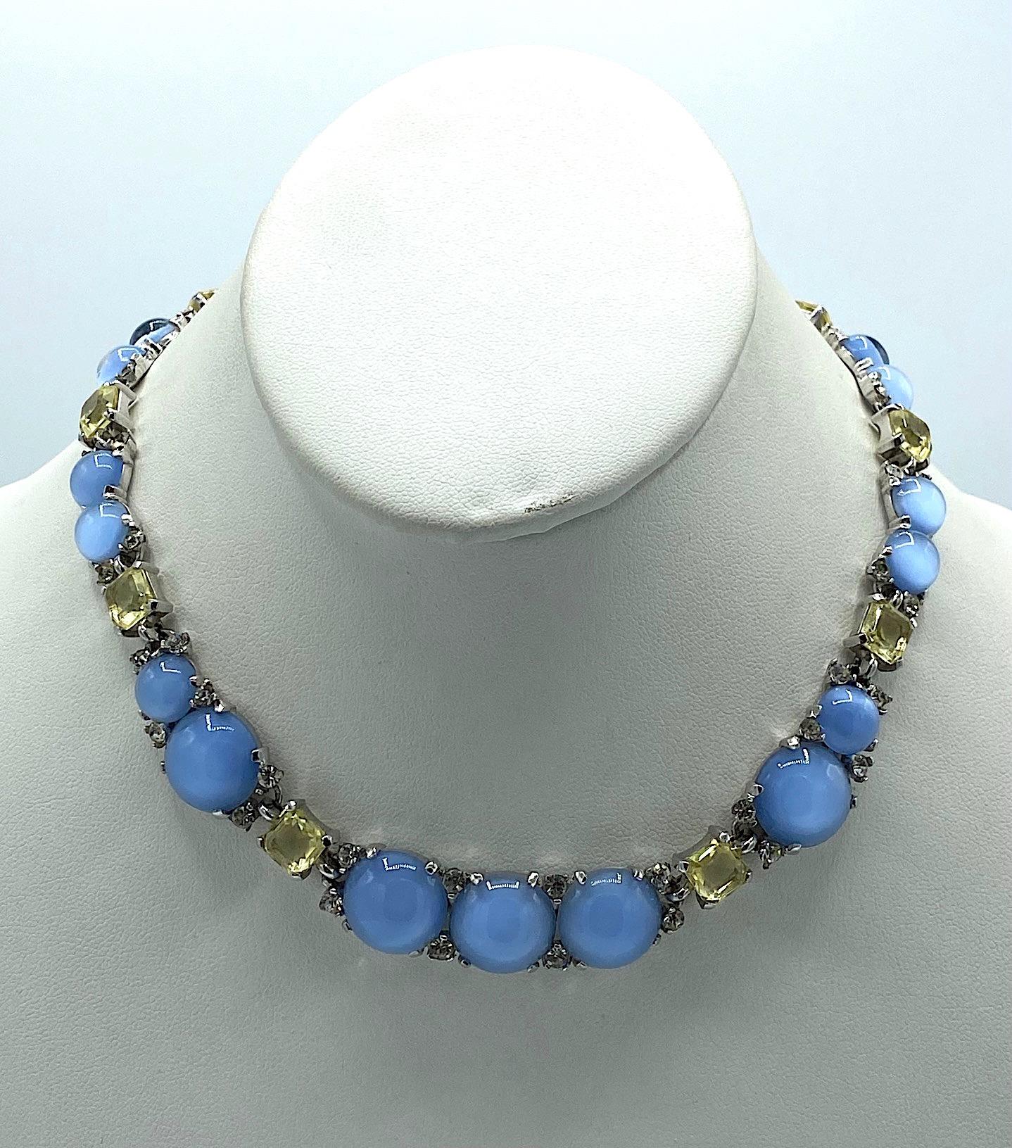 A truly stunning 1950s necklace by famous fashion jewelry company Marcel Boucher. The necklace is meticulously executed in rhodium plate with two sizes of faux glass blue moonstones, fancy yellow crystal emerald cut stones and small accent
