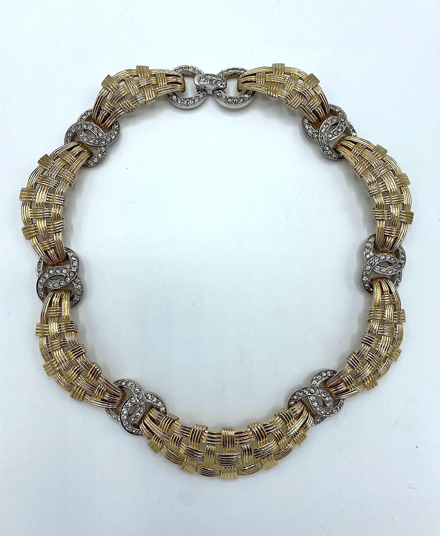 A beautiful and classic vintage 1950s basket weave link necklace with rhinestone ring accents by Marcel Boucher. Seven curved and lightly domed links are cast with an interlocking open basket weave design. Connecting the gold basket links are six