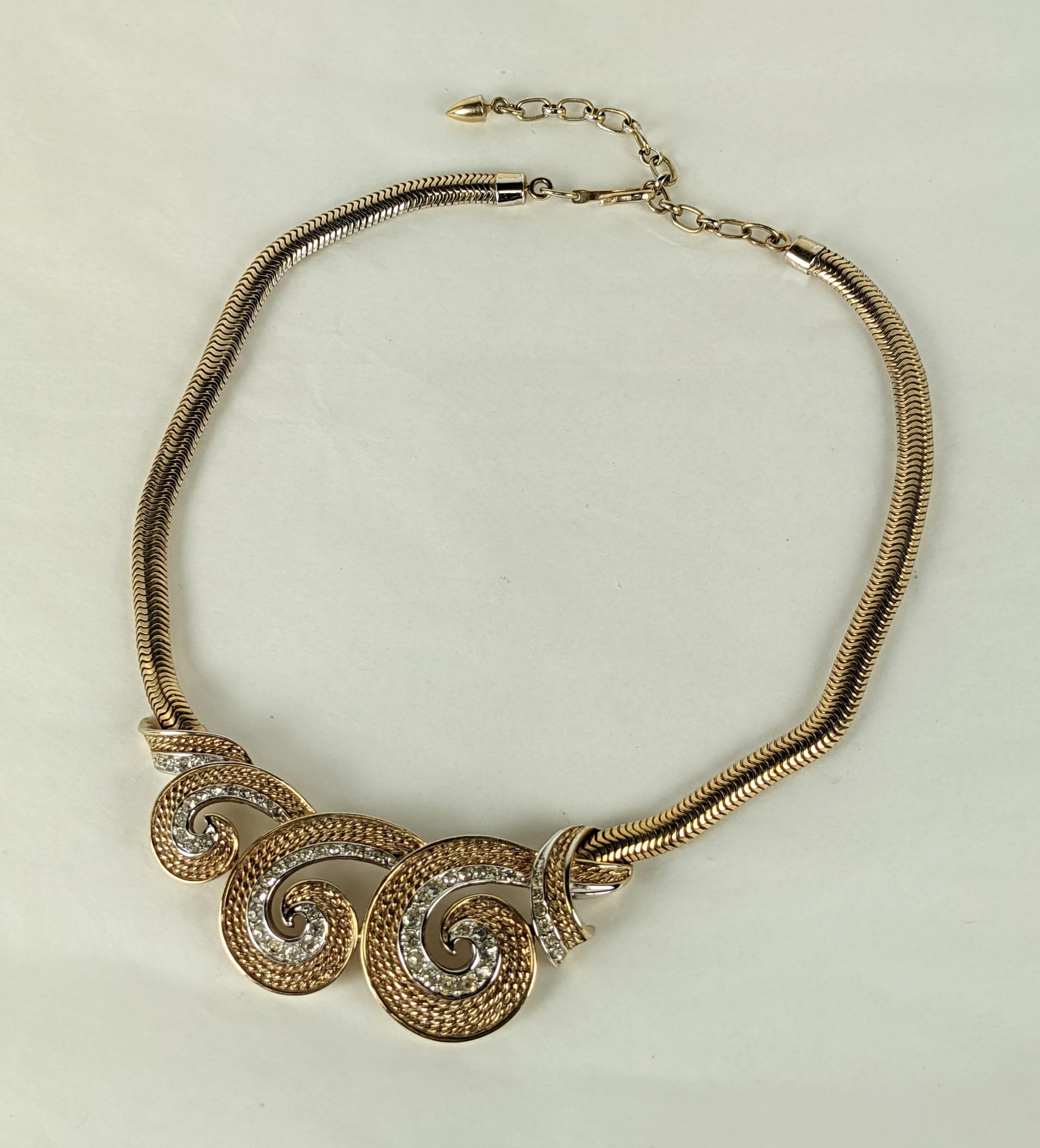 Boucher Pave Scroll Retro Necklace from the 1950's. Scrolled centerpiece is highlighted with pave crystals and hangs from a Retro snake chain. Adjustable chain. 1950's USA.
Signed 
