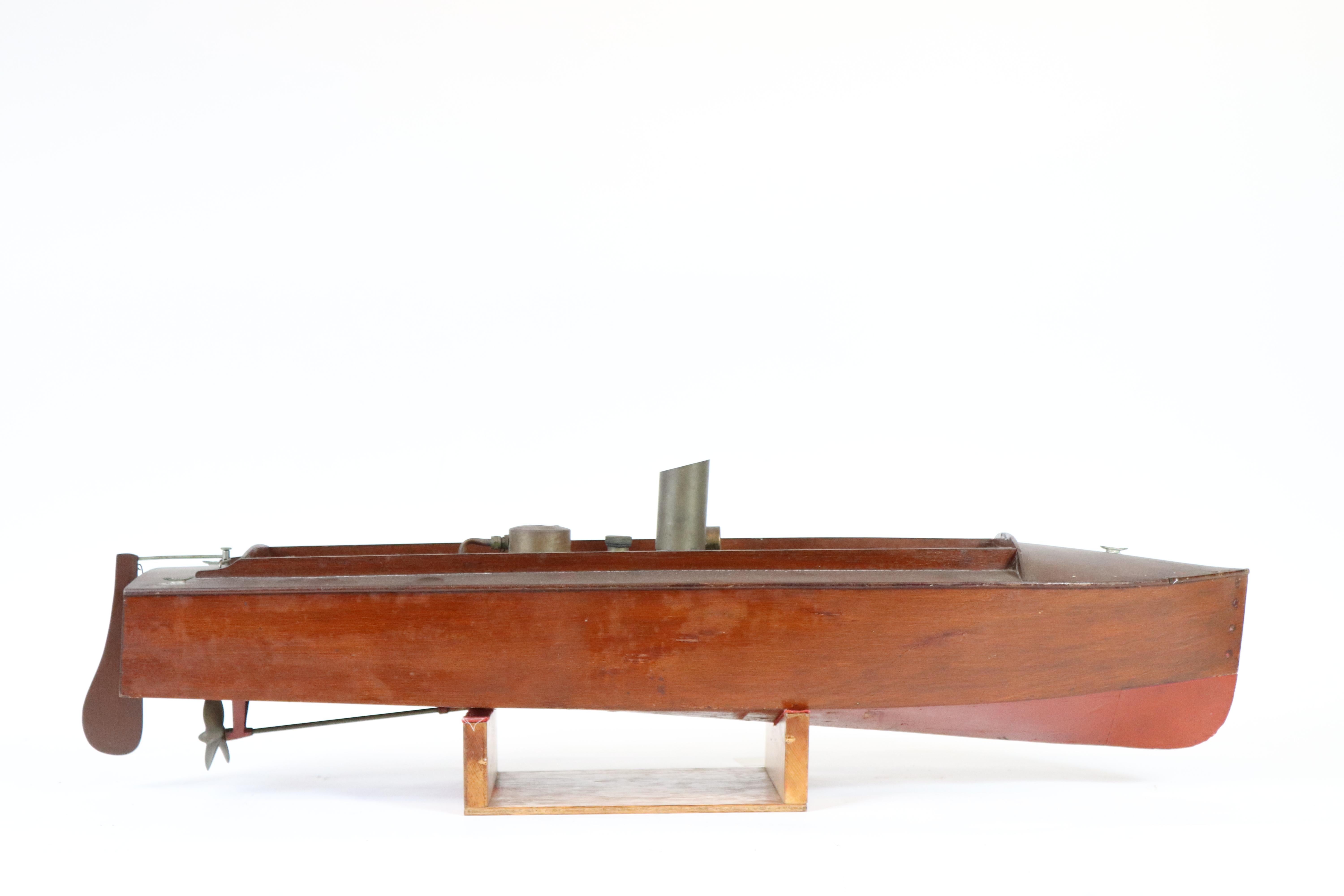 Fine, early steam launch model with maker's plate from H.E. Boucher. The interior has boiler, engine, tank, prop, shaft, etc... In original varnish with red below the waterline. Measures: 37 x 9 x 11.