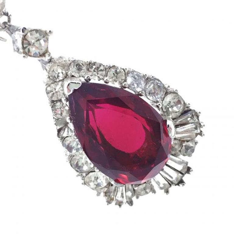 A stunning pair of faux Ruby & Diamond Boucher Earrings dating to the 1950s. The elegant drop style featuring an array of fancy cut crystal stones exudes the very best of the now famous Boucher design. Born in Paris, Marcel Boucher worked as a