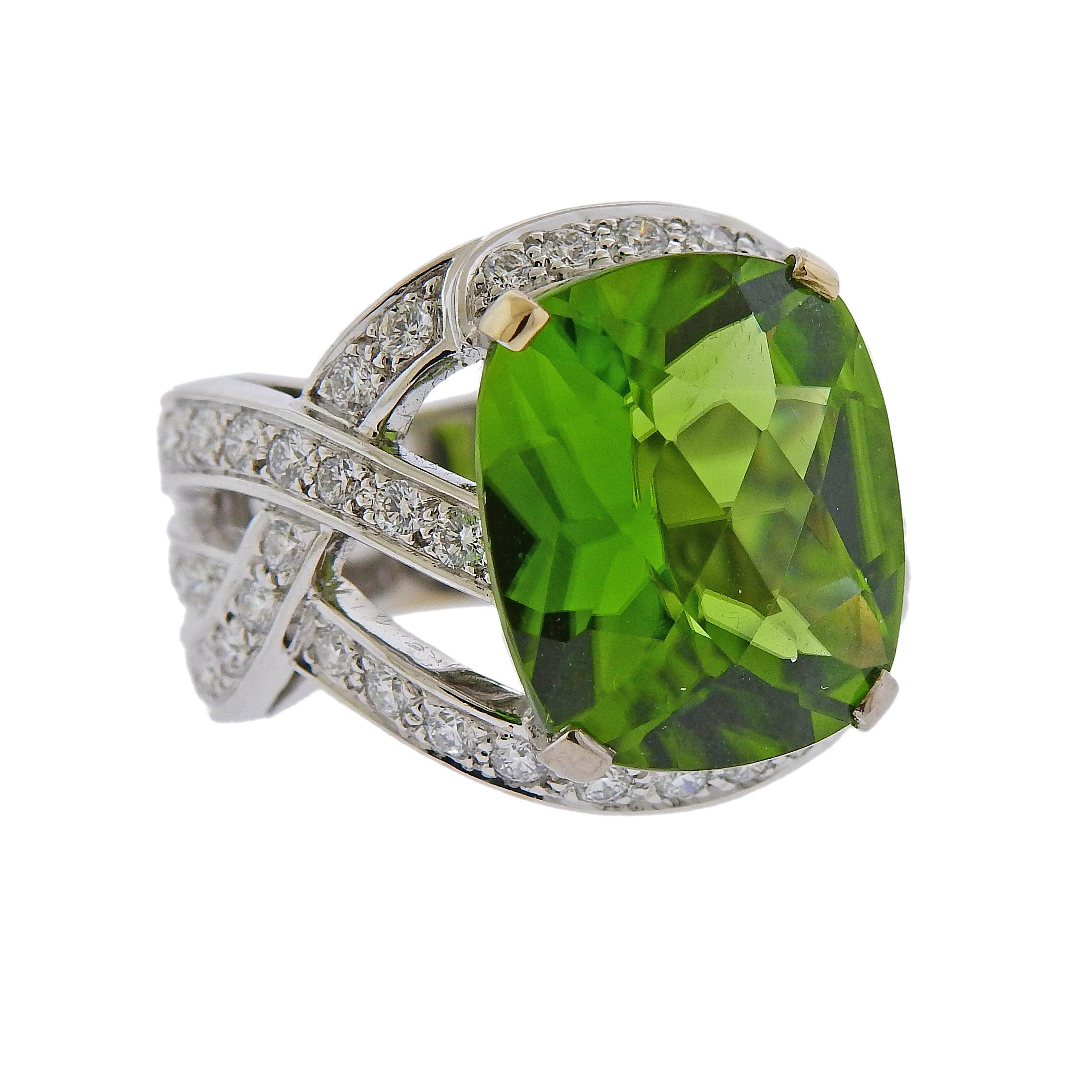 Lage 18k white gold cocktail ring by Boucheron, set with an approx. 12.90 carat peridot, surrounded with approx. 1.10ctw in G/VS diamonds.  Ring size - 6.5, ring top is measured 19mm wide. Weight is 16.8 grams. Marked: or750,53, E36698, Boucheron,