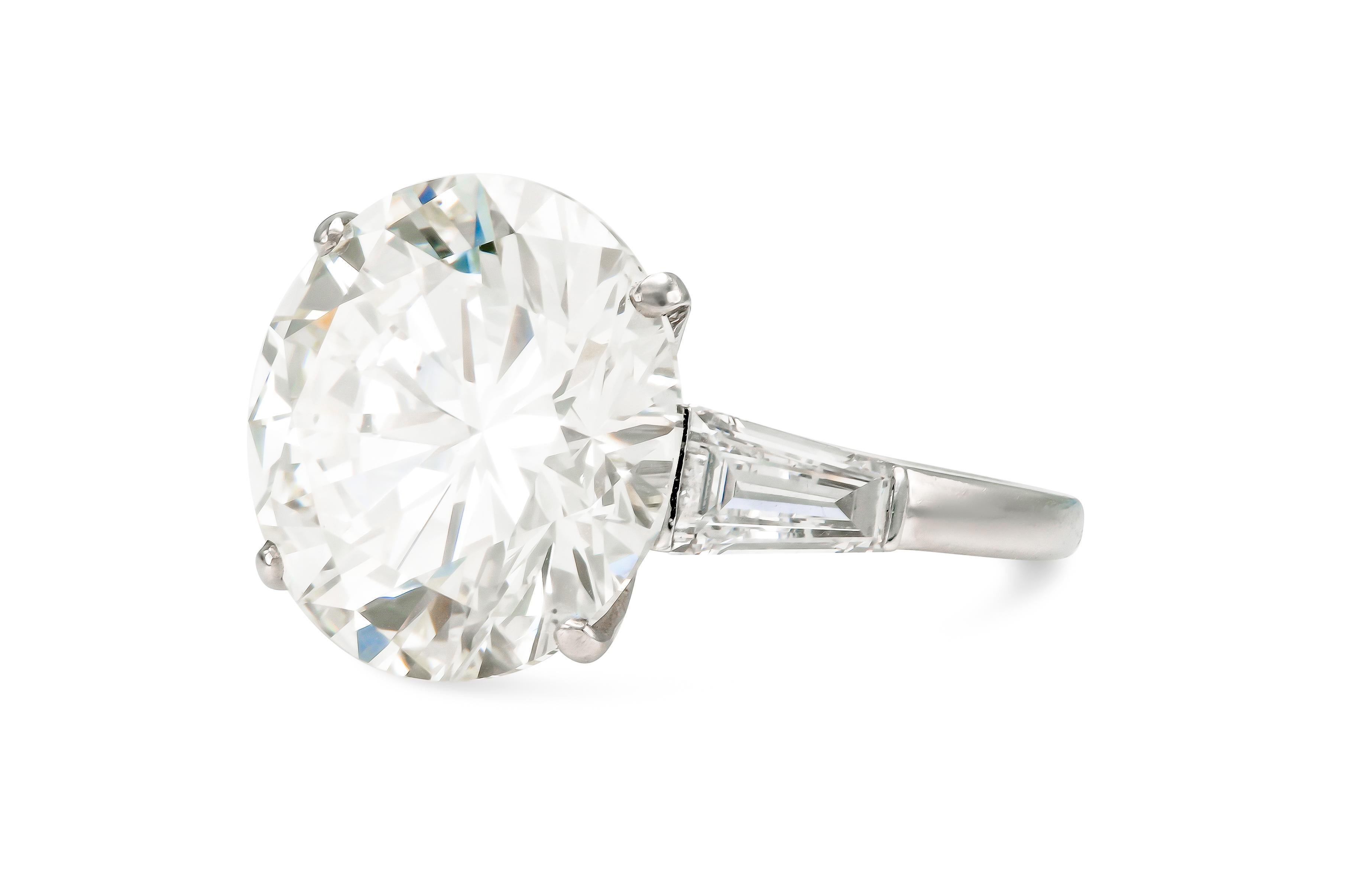 Finely crafted in platinum with a GIA certified Round Brilliant cut Diamond weighing 13.48 carats, M color, VS2 clarity, GIA #6204044105.
The ring features 2 Tapered Baguette cut side Diamonds.
Signed by Boucheron
Size 6 3/4, resizable