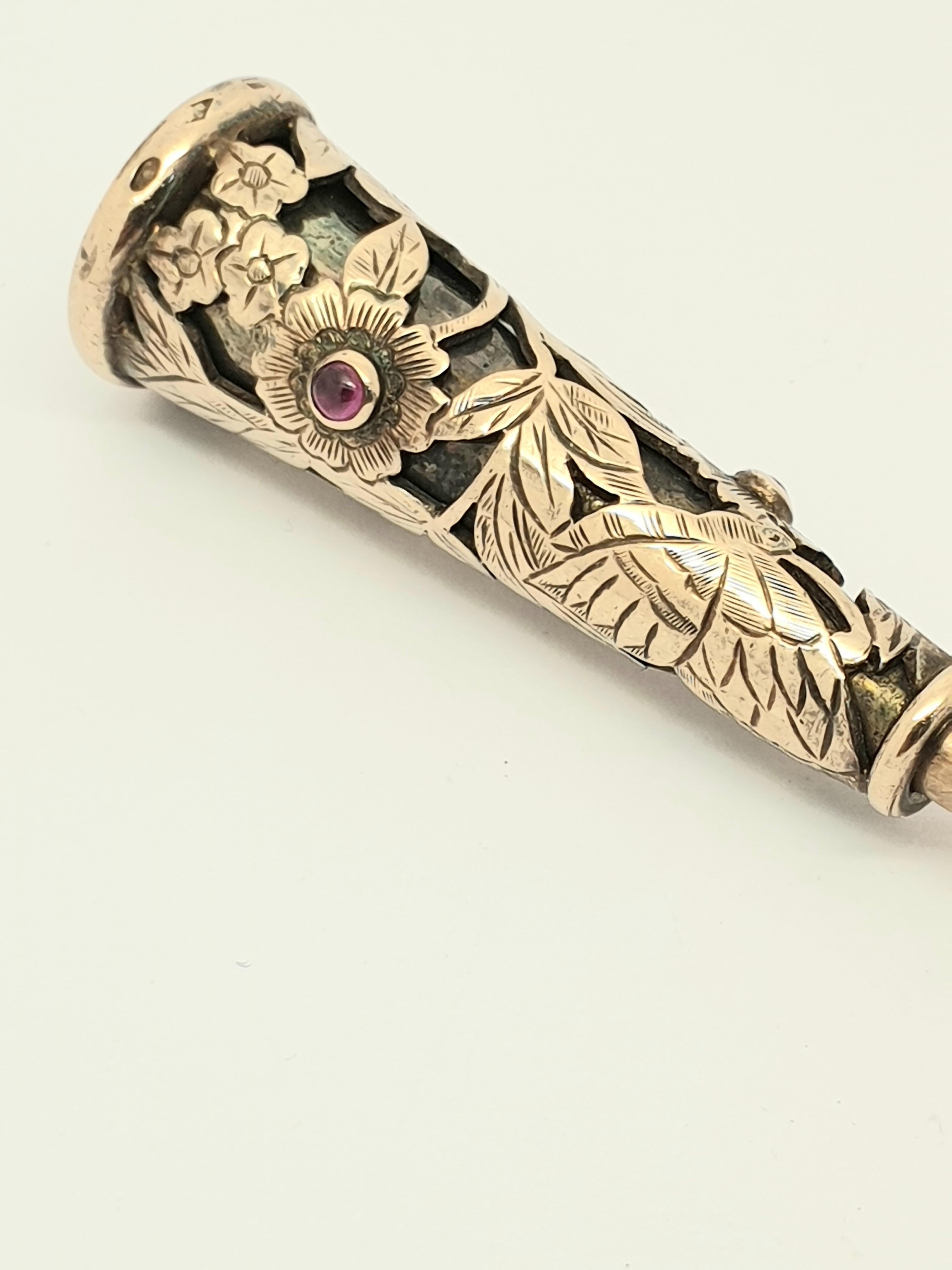 This glamourous mid century cigarette holder is decorated with a pierced engraved scene of  butterflies, floral and foliate motifs, and set with two cabochon rubies. The mouthpiece  is ebony . 
The piece is signed Boucheron Paris and numberd, with