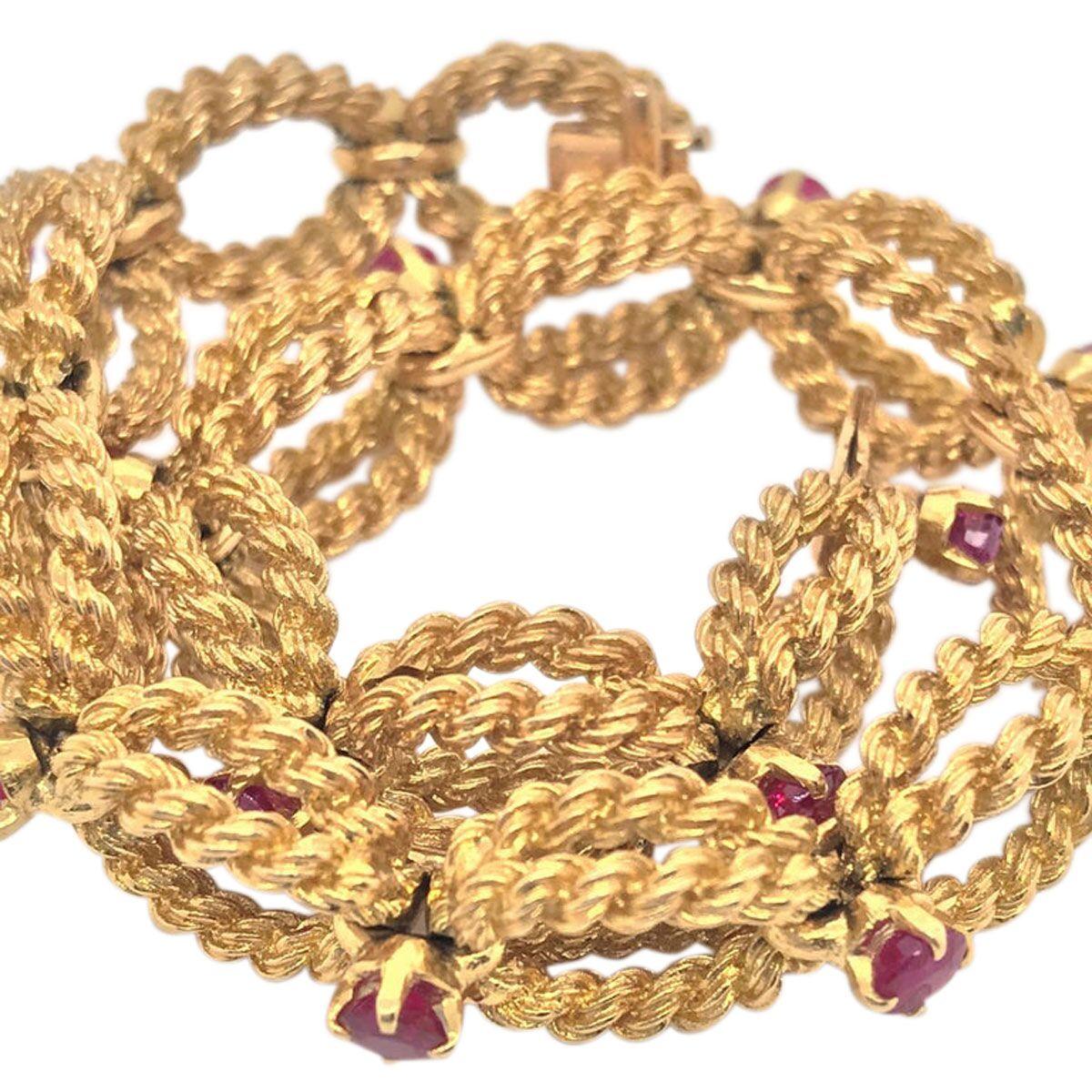 Elegant and so wearable for every occasion, this 18k yellow gold woven rope link bracelet looks sophisticated on the wrist. Each link is separated by a claw set brilliant cut ruby, 14 in all. The craftsmanship is second to none as one would expect