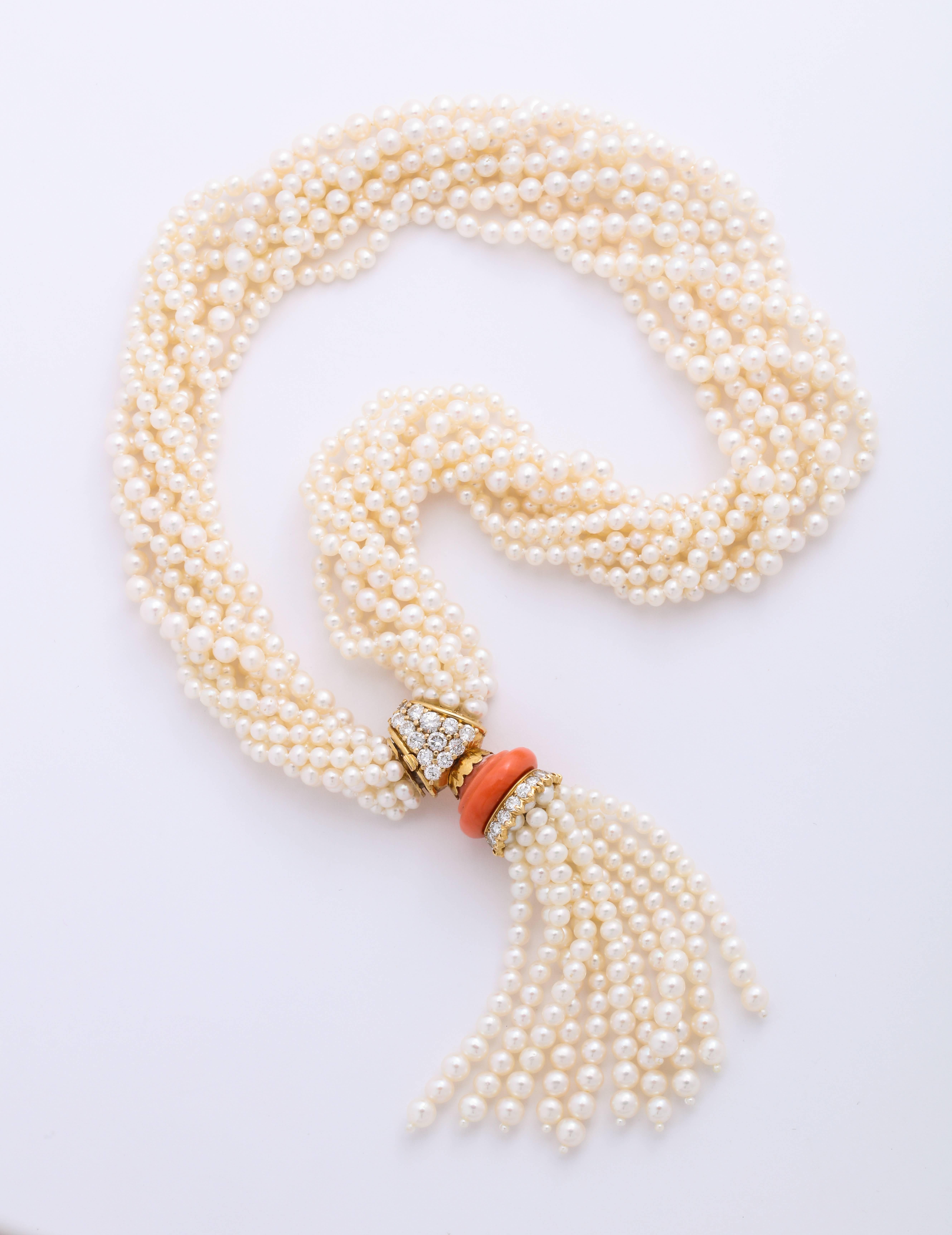A multi-strand pearl torsad necklace set with a coral and diamond clasp, signed 