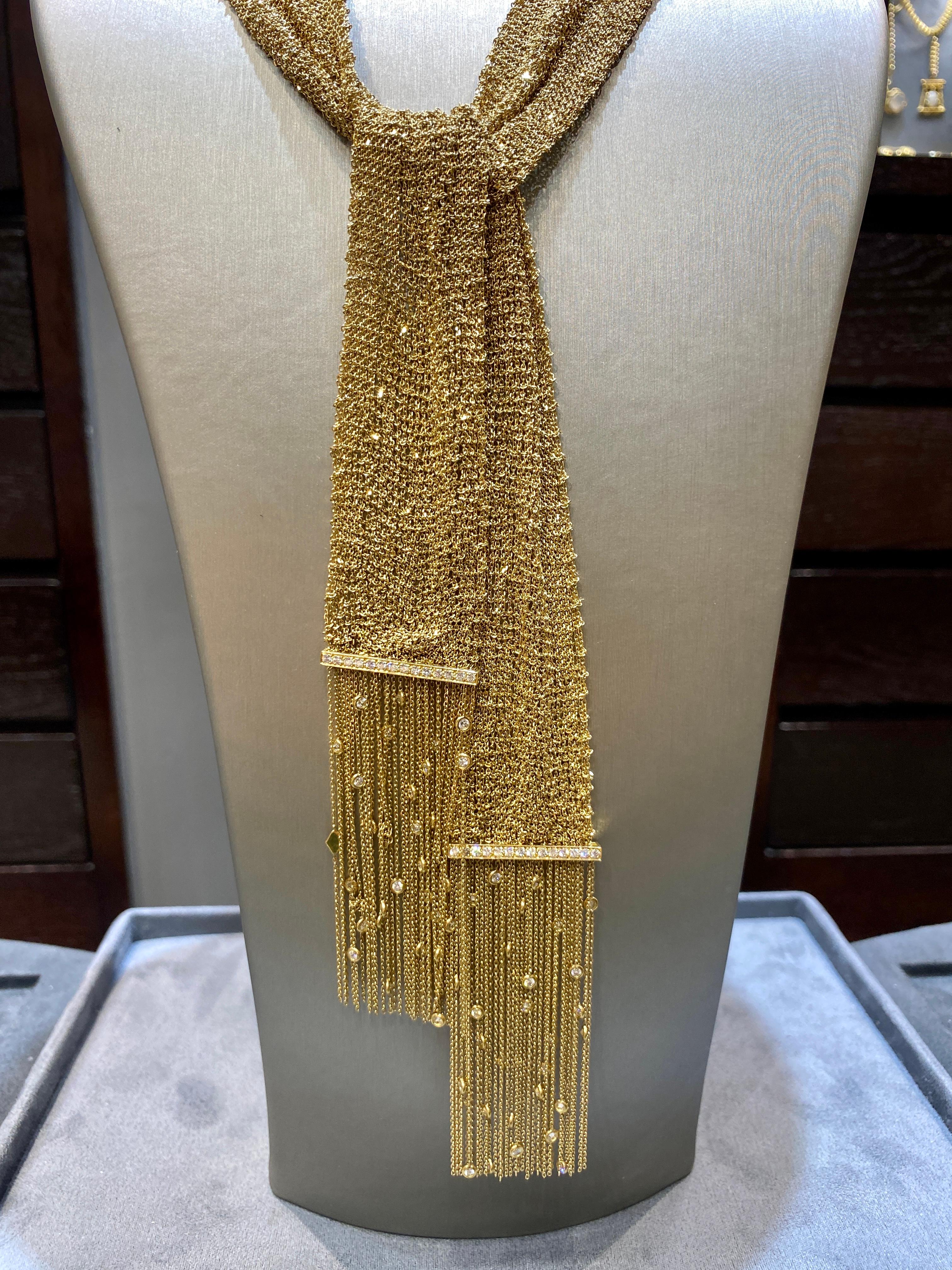 This striking 1980s Boucheron scarf necklace is made of woven 18k gold. The necklace is adorned with approximately 3 carats of diamonds. The necklace is one long golden scarf and can be tied in a number of elegant ways. It is as supple as silk.