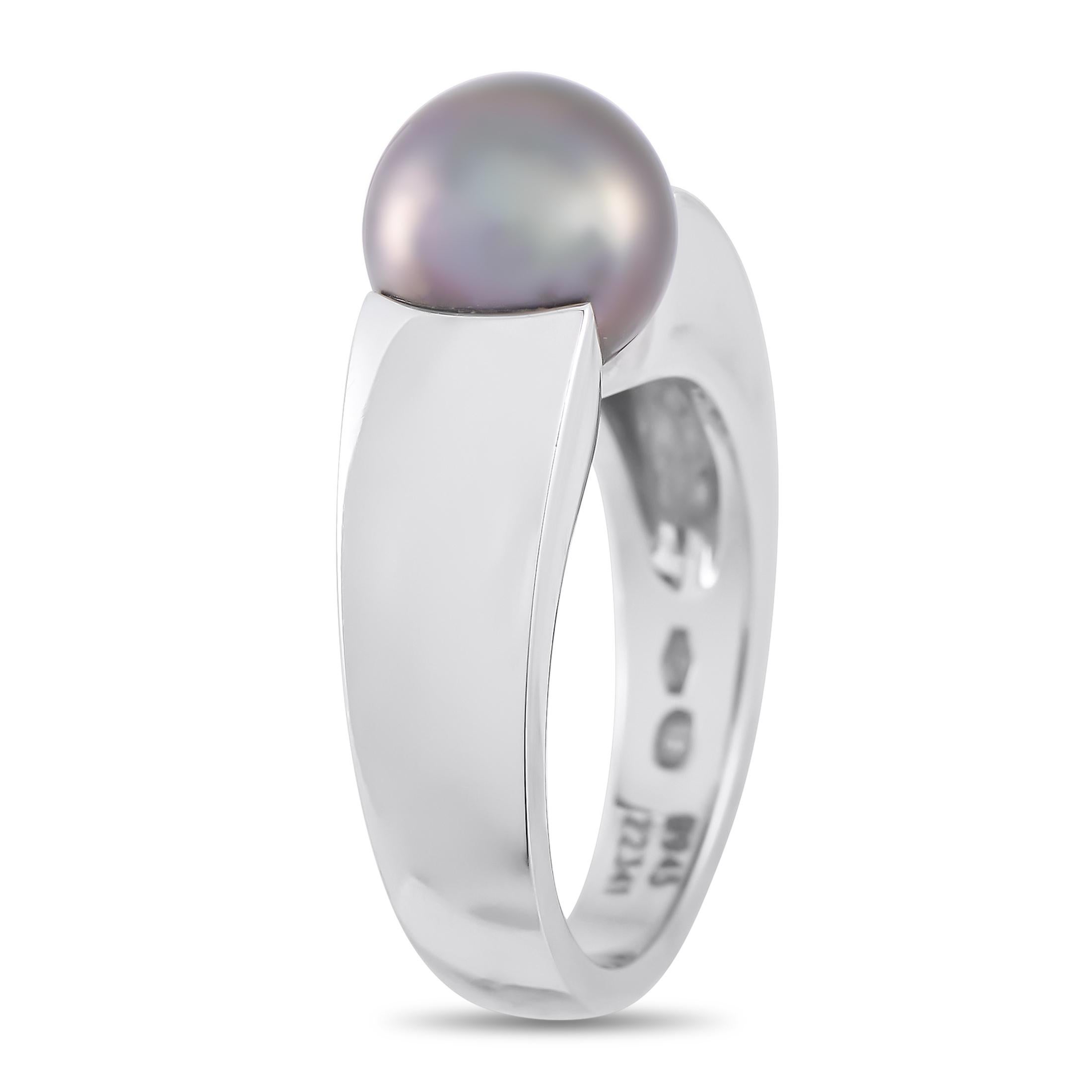 This Boucheron ring is simple, stylish, and ideal for everyday wear. At the center of this pieces sleek 18K White Gold setting, a dark Pearl center stone serves as a stunning focal point. This impeccably designed accessory features a 5mm wide band