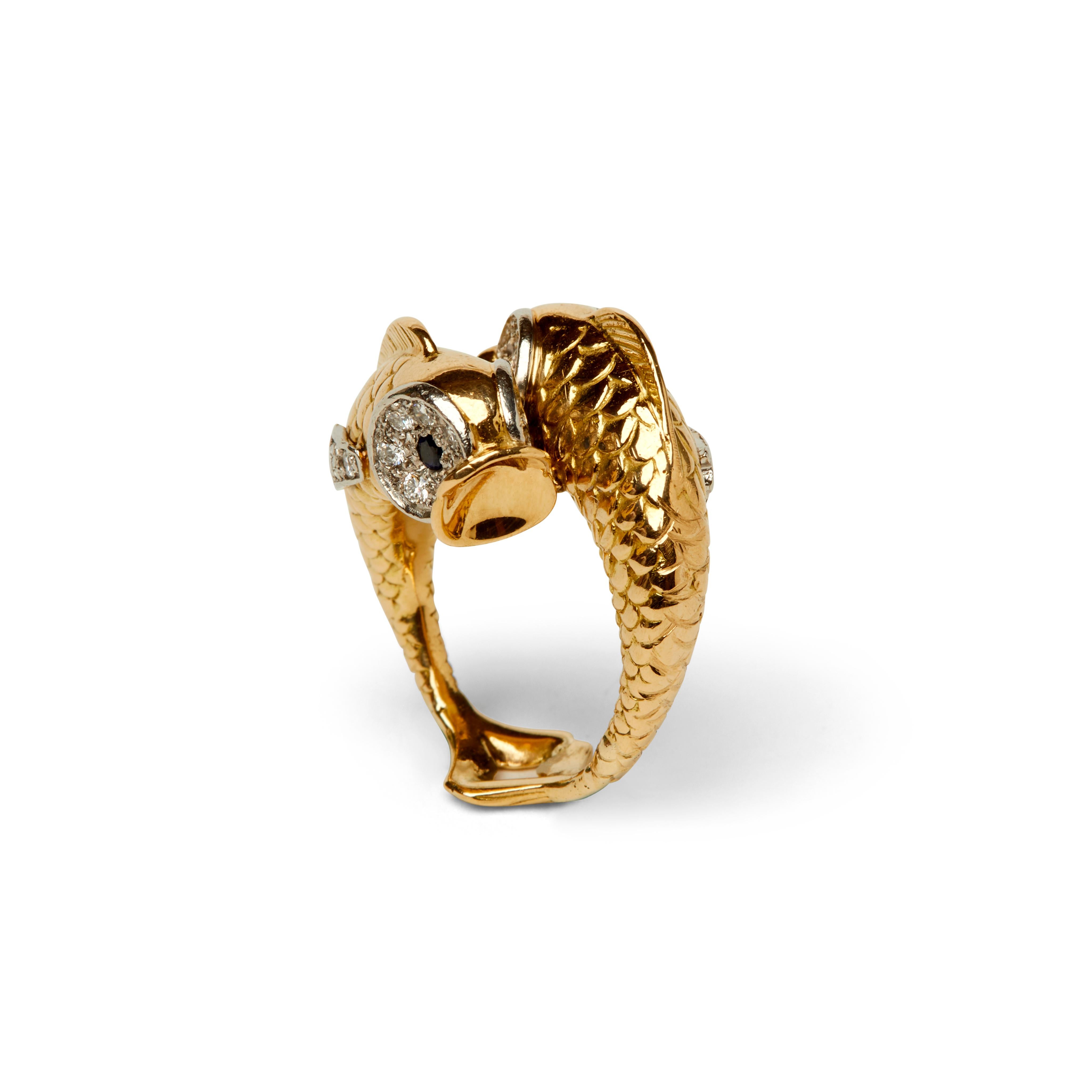 This eye-catching vintage Boucheron ring is designed as two stylized fish in a crossover design set with round brilliant-cut diamonds and circular cut sapphire eyes.

- Size 5.75
- 24 round brilliant-cut diamonds weighing approximately 1.00 carats
-