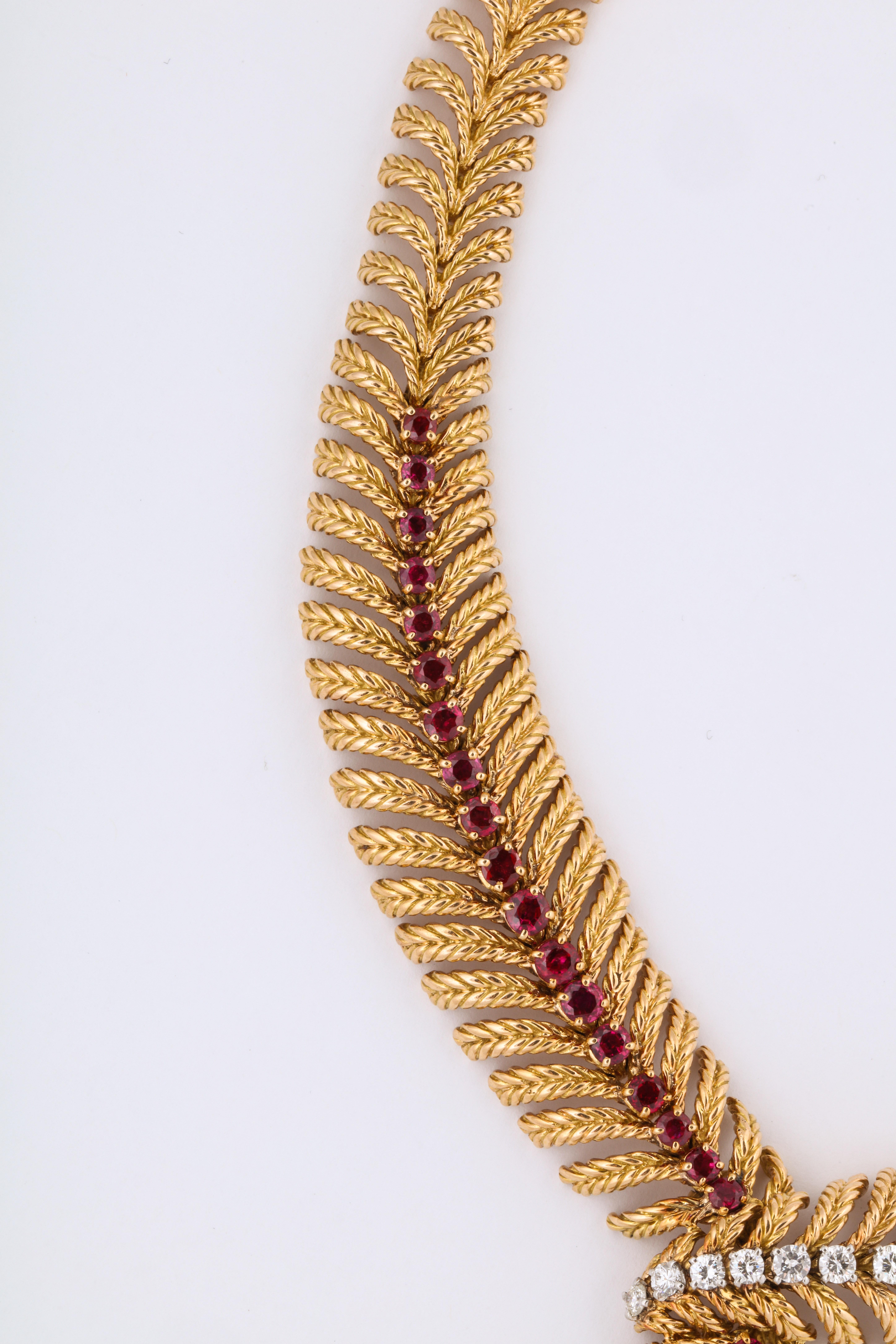 An amazingly soft and flexible textured gold necklace made in Paris in 1960 with a row of red, red rubies and a diamond cross over.  Classic box clasp with tongue and safety closure at the back.  This necklace is so supple and perfectly achieves