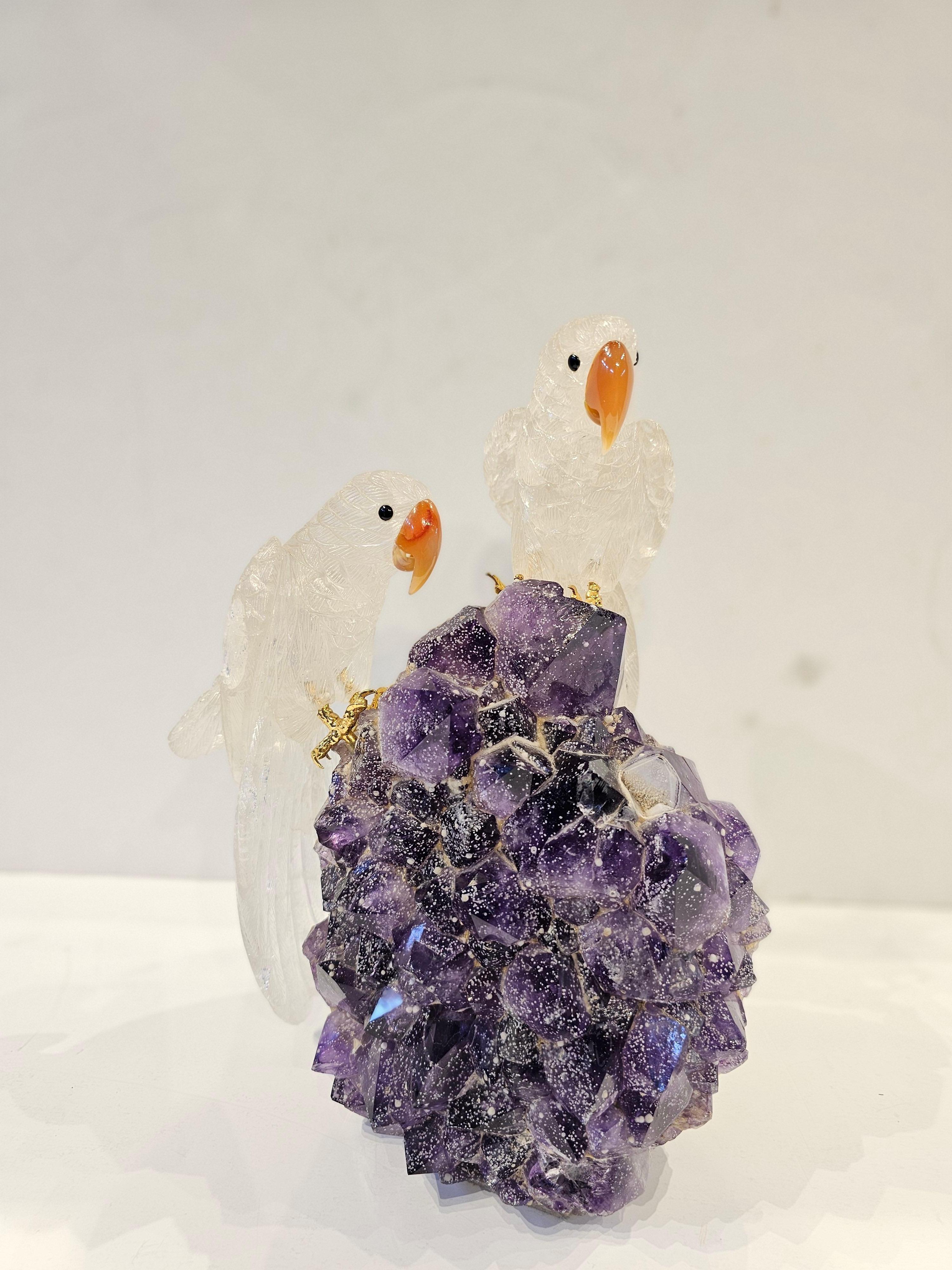 Large Boucheron Amethyst & Rock Crystal Bird Desk Object
 
A large rough amethyst crystal adorned with a pair of beautifully carved rock crystal parrots with carnelian beaks, onyx eyes, and 18 karat gold claws

Signed Boucheron 

Circa