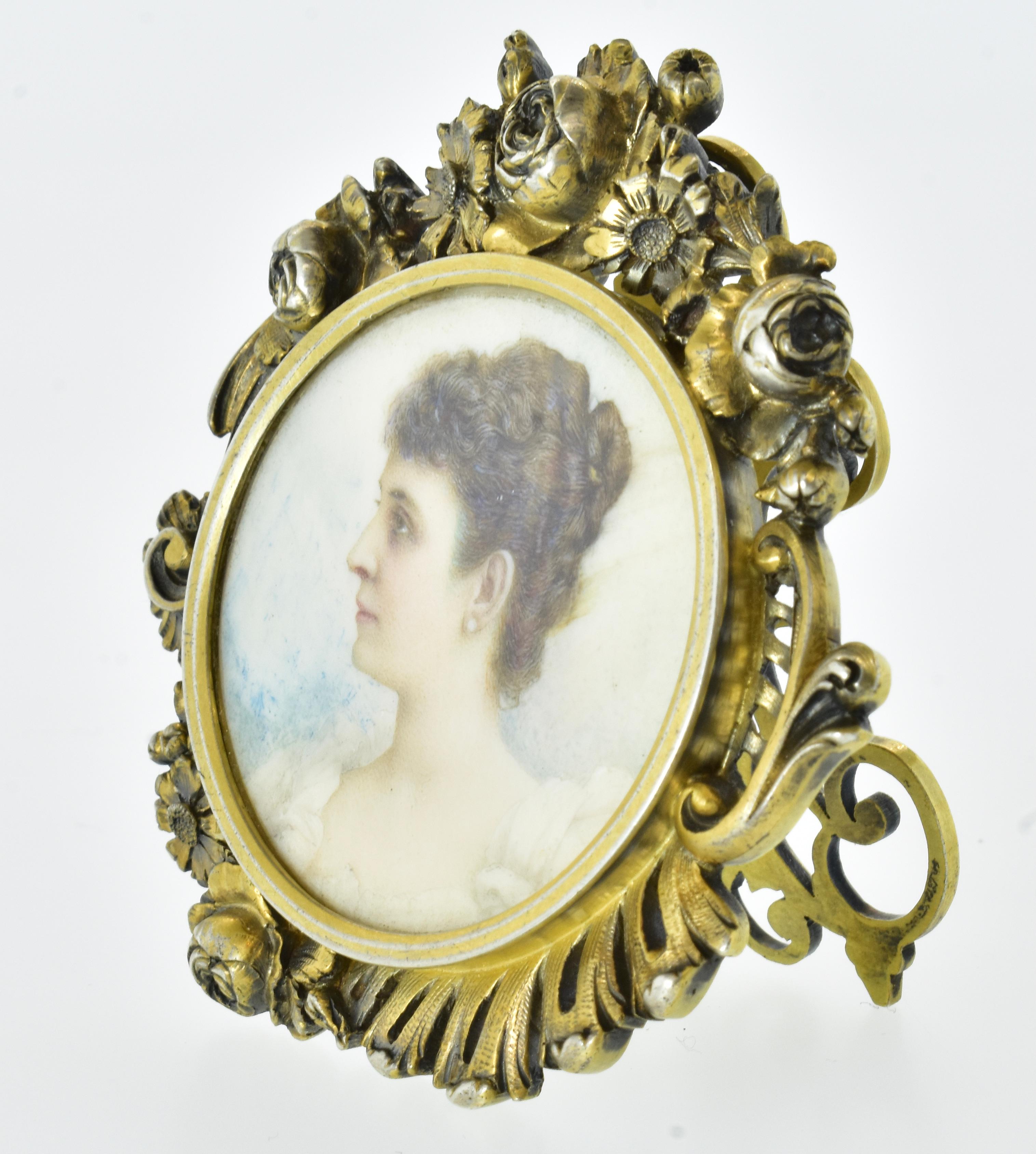 Frederic Boucheron small ornate frame holding a fine miniature oil painting.
 Probably designed by Jules Debut, a major designer for Boucheron in the late 19th century.  1988. He designs of picture frames imitated wrought iron work with carved