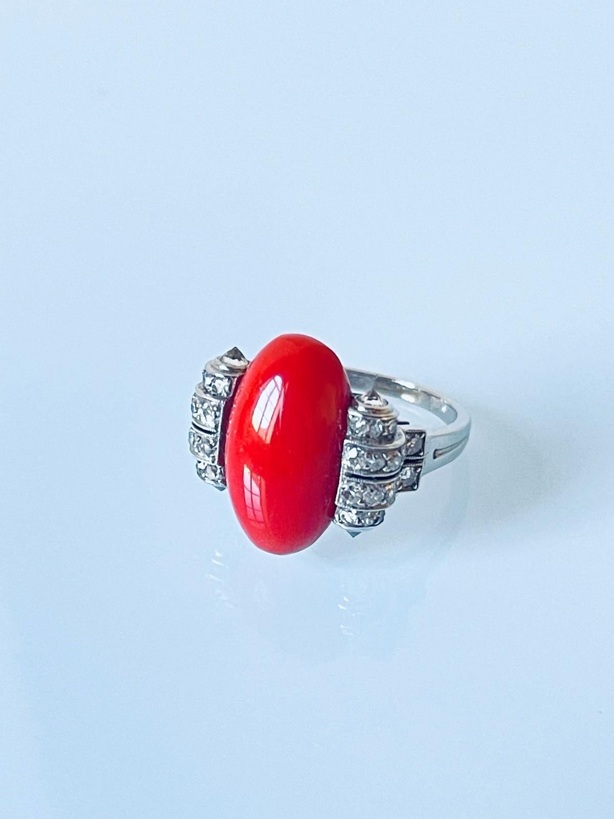 Extremely elegant and rare to find original Art Deco period ring by Boucheron. The ring is centred with a fine quality medium salmon colour natural coral cabochon embellished by 8 rows of millegrain diamonds set in a geometric design and domed by 4