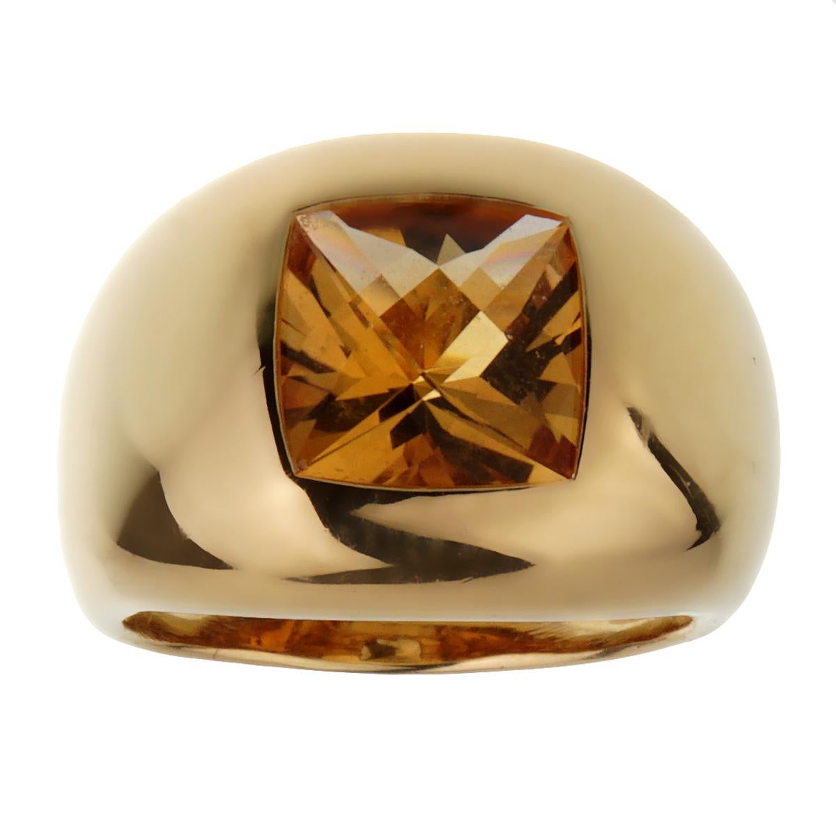 A chic Boucheron cocktail ring showcasing a step cut citrine set in 18k yellow gold. The ring measures a size 6 1/4 and can be resized.