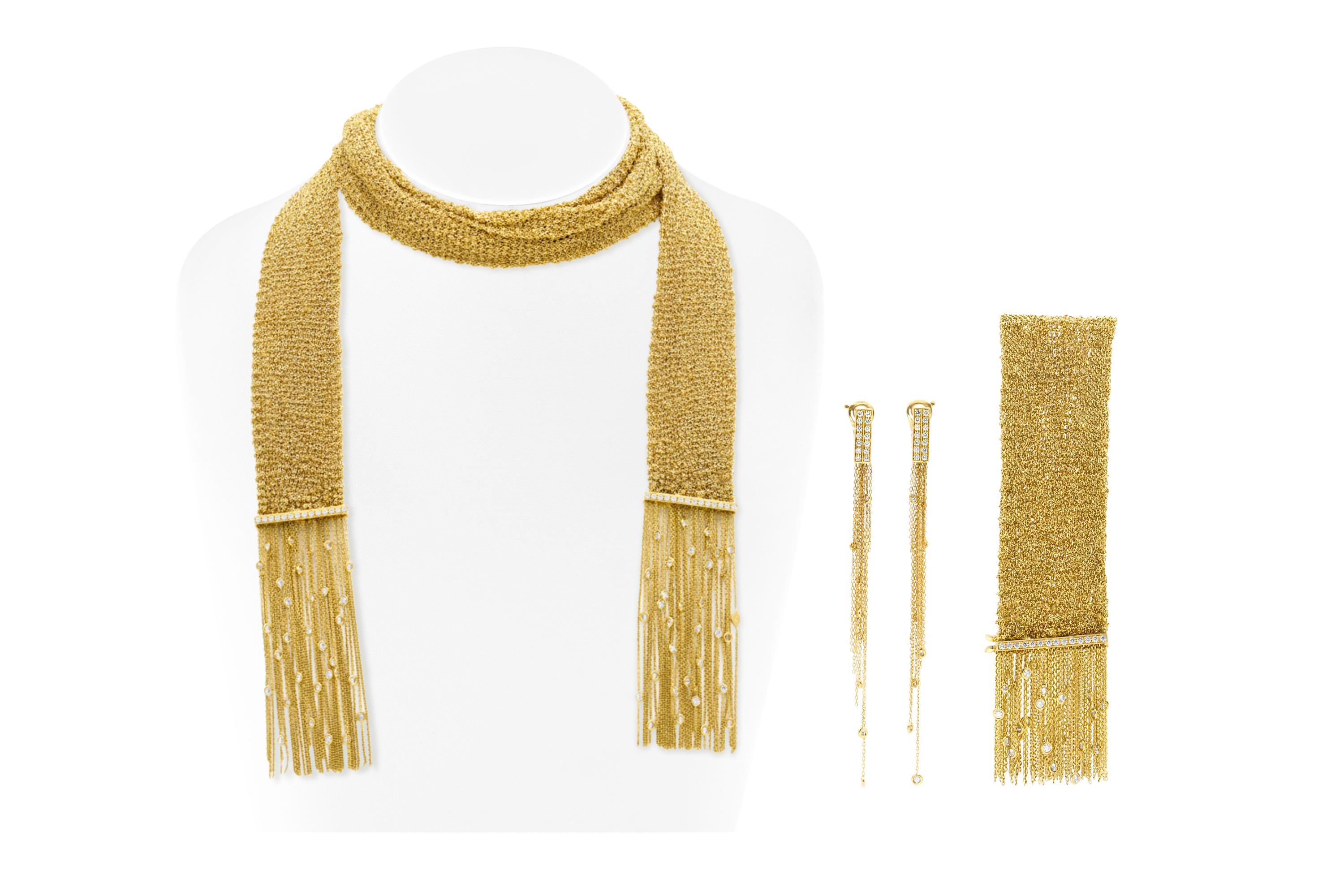 Finely crafted in 18k yellow mesh gold with Round Brilliant cut diamonds on the bars and tassels.
The bracelet measures 7 inches + 1 1/4 inch fringe
The scarf necklace measures 41 1/2 inches + 2 3/4 inch fringe
The earrings measure 4 inches