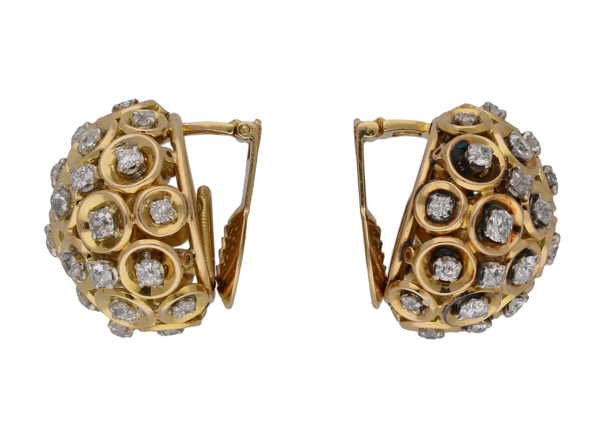 Boucheron diamond and gold clip earrings. A matching pair, each set with thirty one round mixed old cut diamonds in open back claw settings, sixty two in total with a combined approximate weight of 5.80 carats, to a pierced bombé cluster design