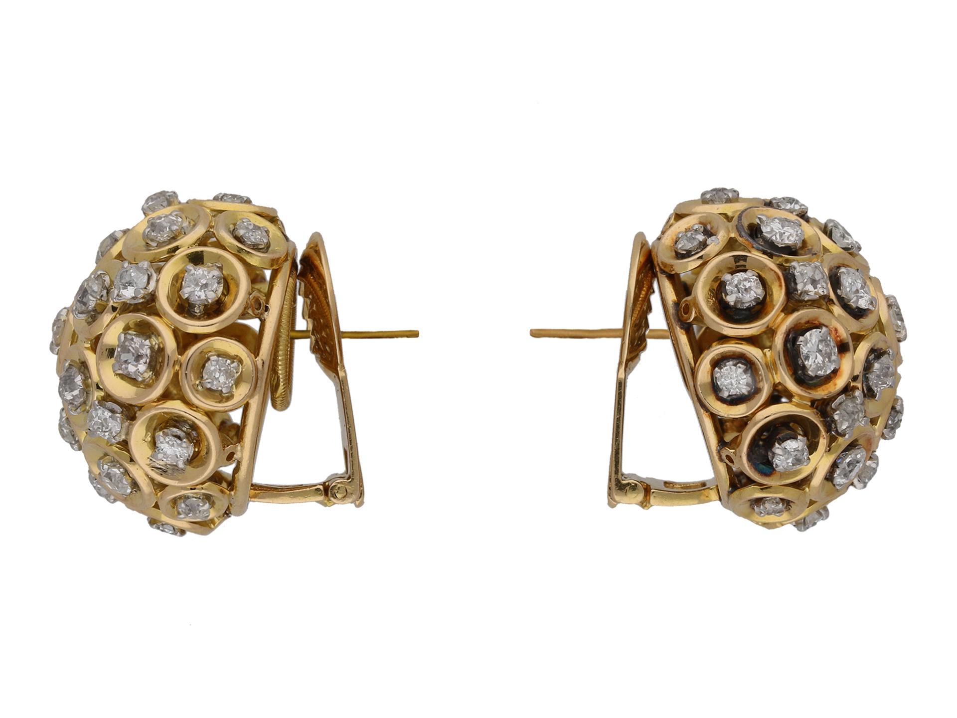 Boucheron diamond and gold clip earrings. A matching pair, each set with thirty one round mixed old cut diamonds in open back claw settings, sixty two in total with a combined approximate weight of 5.80 carats, to a pierced bombé cluster design