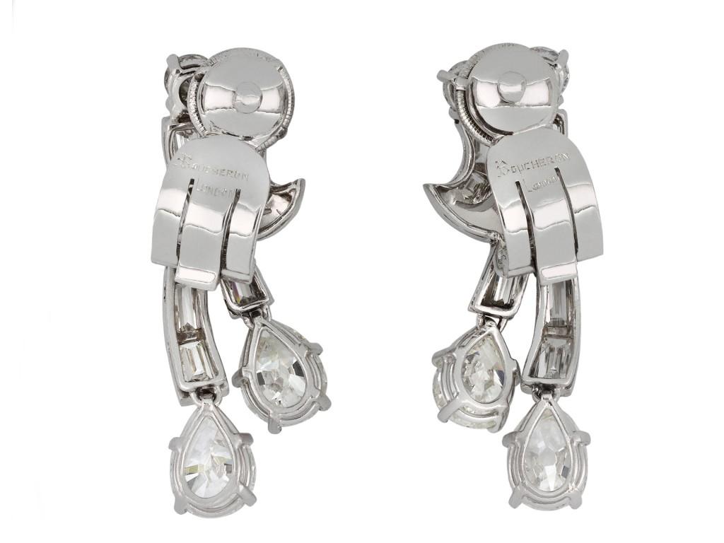 Boucheron diamond clip earrings. A matching pair, each set to bottom with two drop shape old cut diamonds in open back claw settings, four in total with an approximate combined weight of 3.60 carats, set to top with two round transitional cut
