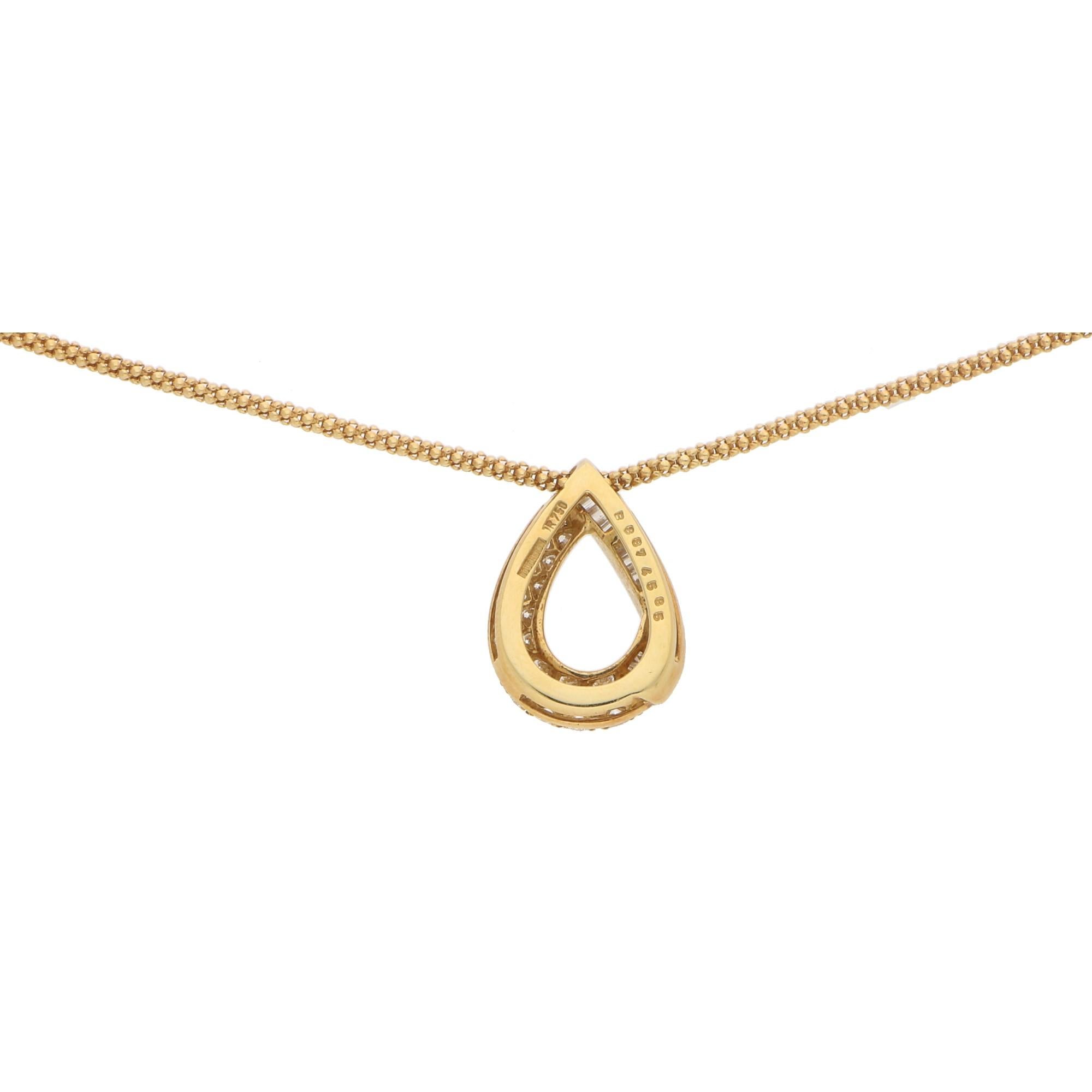 A rather interesting Boucheron diamond pendant and chain set in 18k yellow gold. The pendant is beautifully crafted and designed as an open pear-shape bombe loop. It is pave set half-way with 31 round brilliant cut diamonds with the other half of