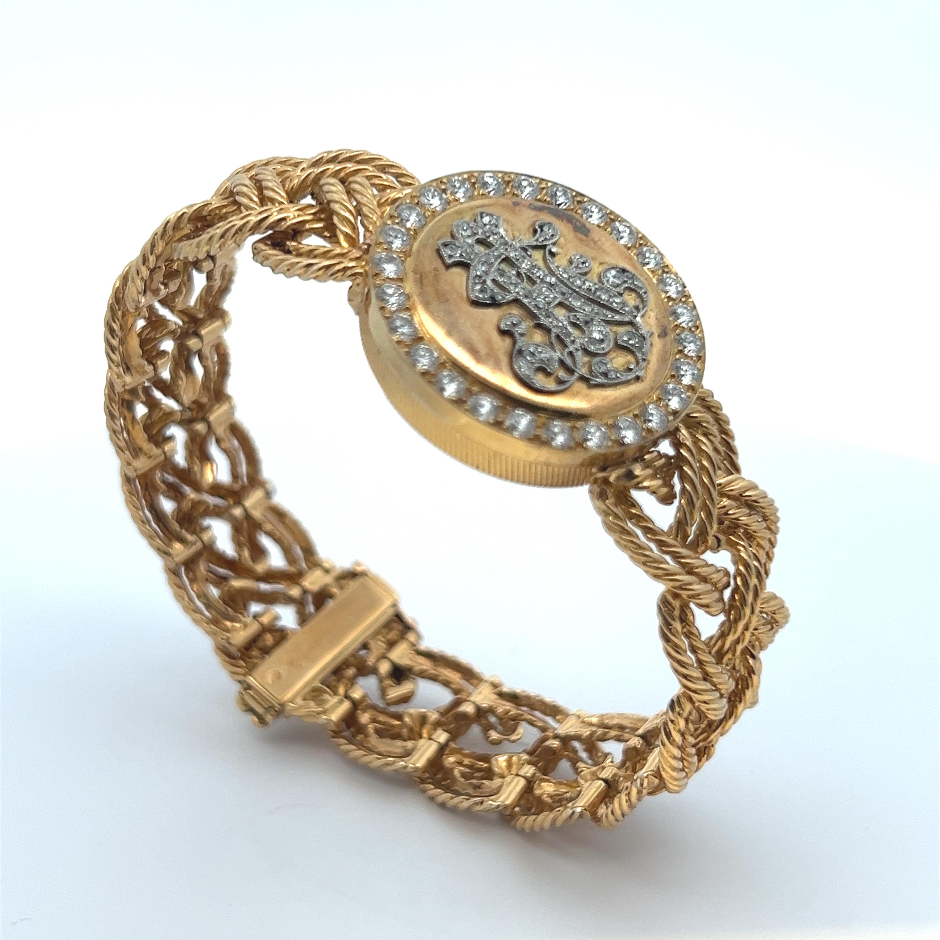 Boucheron Diamond & Gold Locket Watch. 

A gold watch featuring a diamond Monogram opening to reveal a white Vacheron Constantin dial watch

Measurements: 2.5