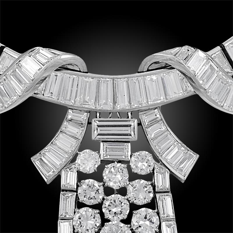 A truly magnificent 1950's Boucheron diamond necklace. Designed as a stylised, flexible ribbon set with graduated and tapered baguette & step-cut diamonds, suspending an articulated cascade of graduated brilliant-cut and baguette diamonds. The