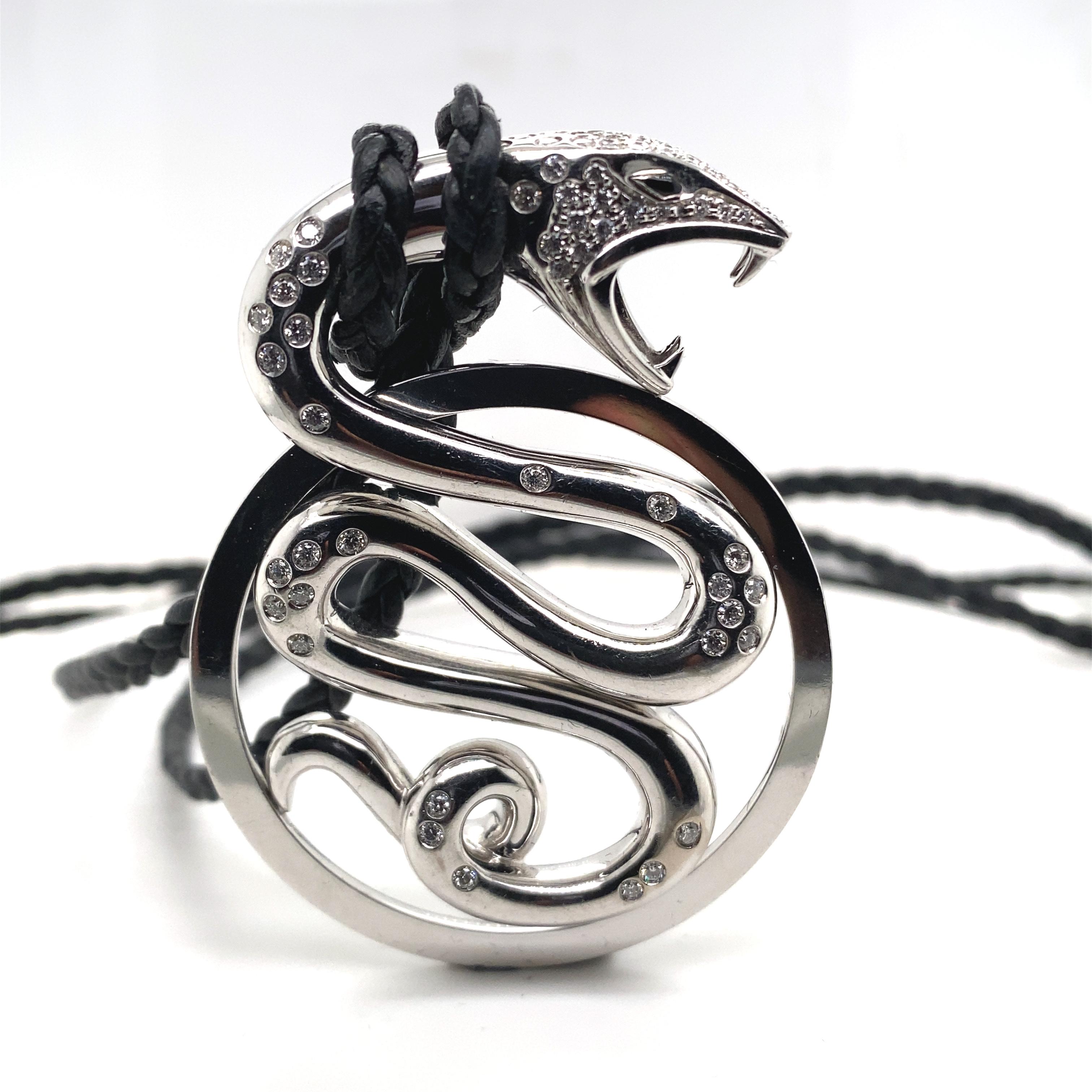 A Boucheron diamond snake 'Trouble' 18 karat white gold Large Pendant Necklace, circa 2005

This striking pendant from the 'Trouble' collection by Boucheron is formed as a snake, an iconic guardian and a cultural symbol of protection it has black