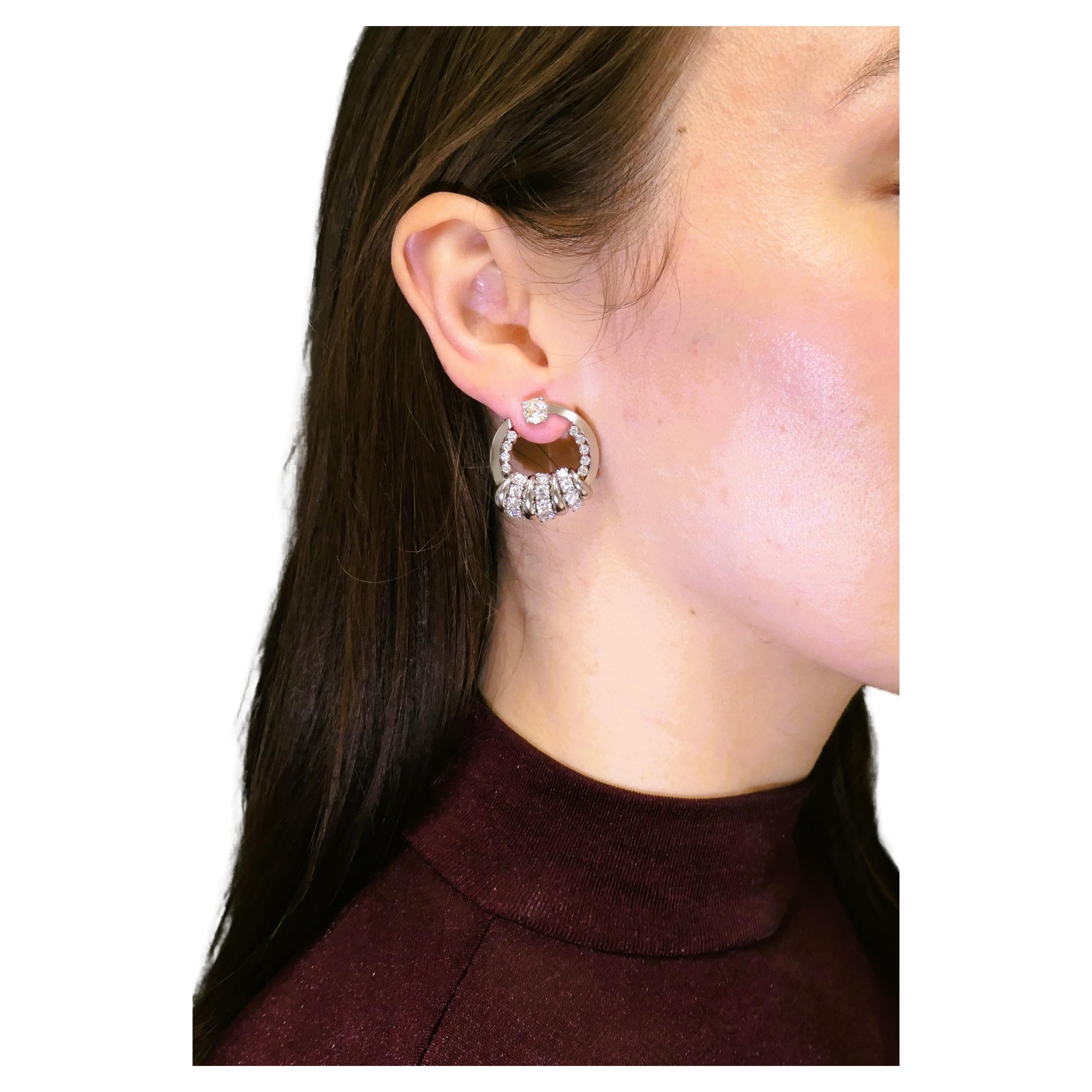 A gorgeous pair of vintage Boucheron door knocker earrings, crafted of platinum and diamond. The gemstones are of cushion, transitional round brilliant and single cuts that make these door knockers look unique. 
The single cut diamonds are bezel set