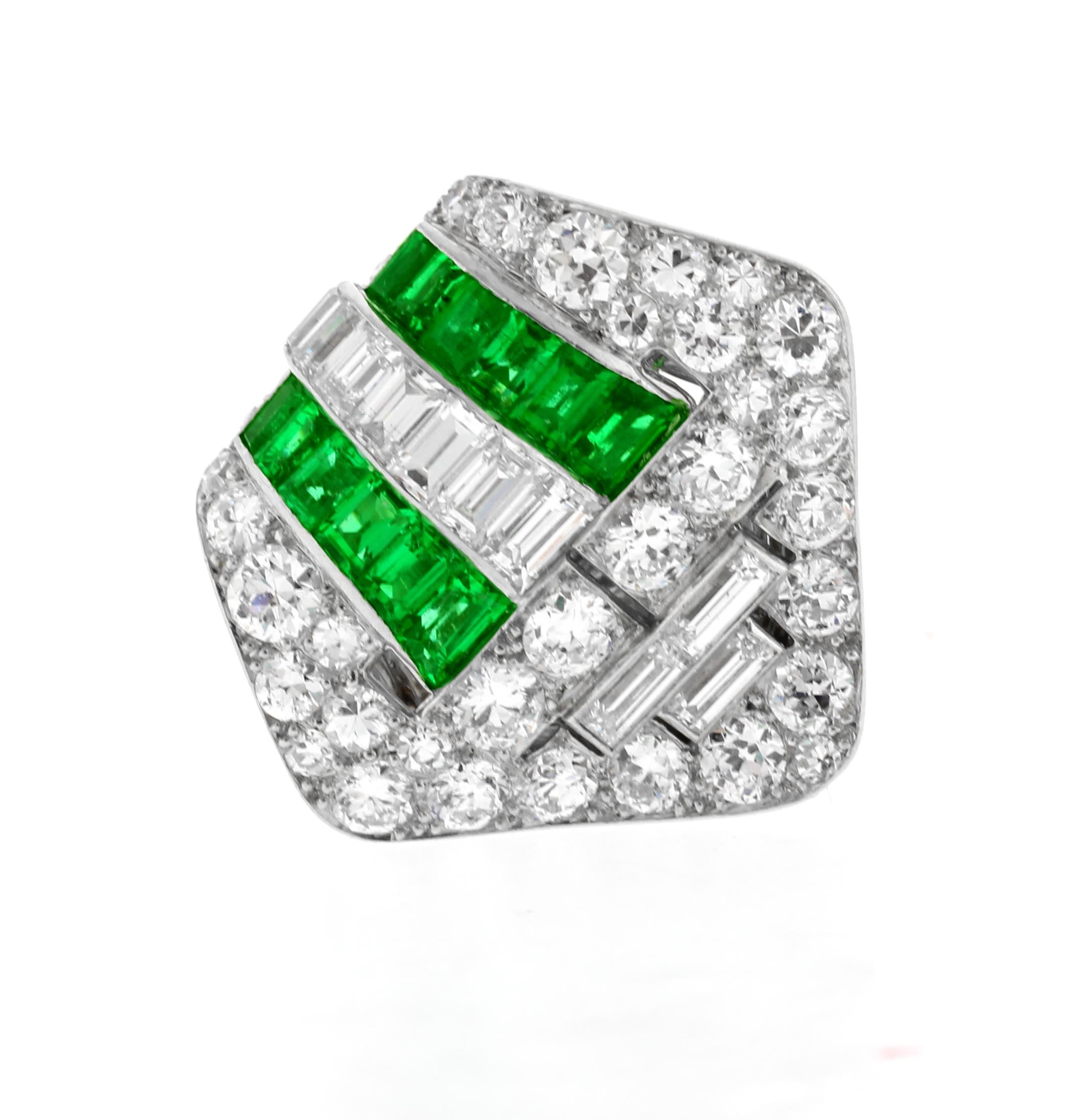 From Parisian jeweler Boucheron this absolutely fabulous Art Deco Emerald and diamond clip brooch. The brooch feature 4½ carats of shimmering diamond and  1.25 carats of the finest gem  Columbian emeralds. Maybe clipped over a lapel, collar, cuff or