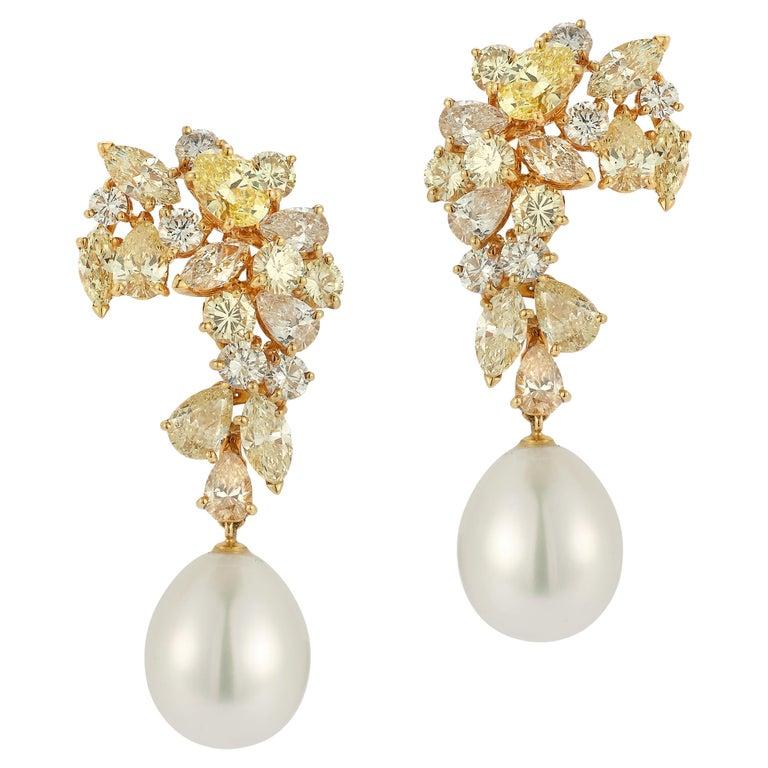 Boucheron Fancy Colored Diamond and Pearl Earrings

Pear, marquise, oval and round colored diamonds including pink, brown and yellow set with white cultured drop-shaped pearls.

Diamond Weight: approximately  9.50 cts
Diamonds: on average of VS to
