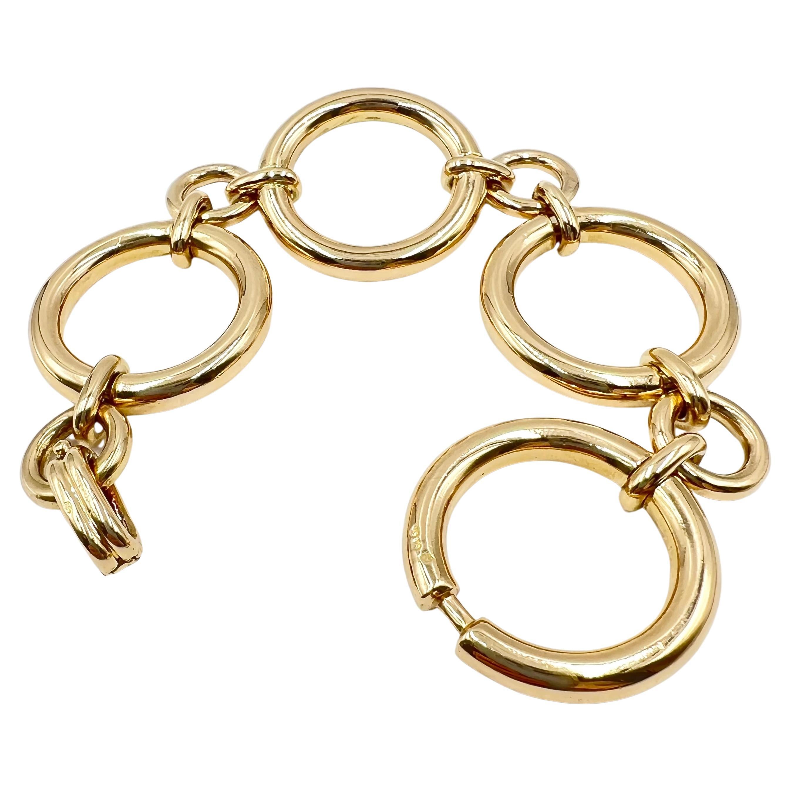 Boucheron French circular link bracelet in 18kt yellow gold.  Classic 1960's design comprised of four larger circular links joined by four smaller, tubular links. Signed 
