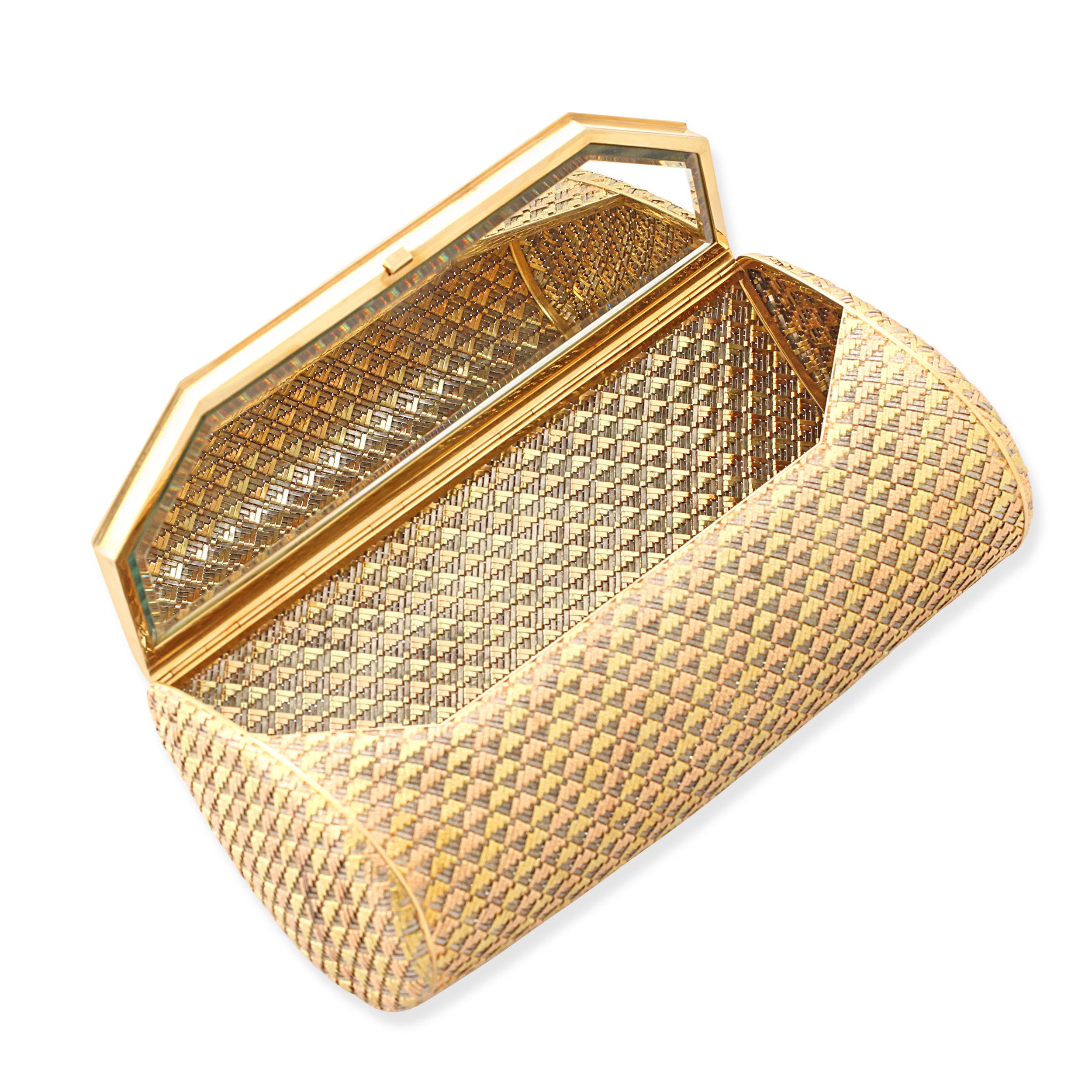 A French 18k gold clutch bag by Boucheron. Woven from 18k yellow, rose and white gold in a textured design with a mirror inside. French assay marks & makers mark for Soubrenie et Bois. Soubrenie et Bois made vanity cases, compacts, cigarette cases