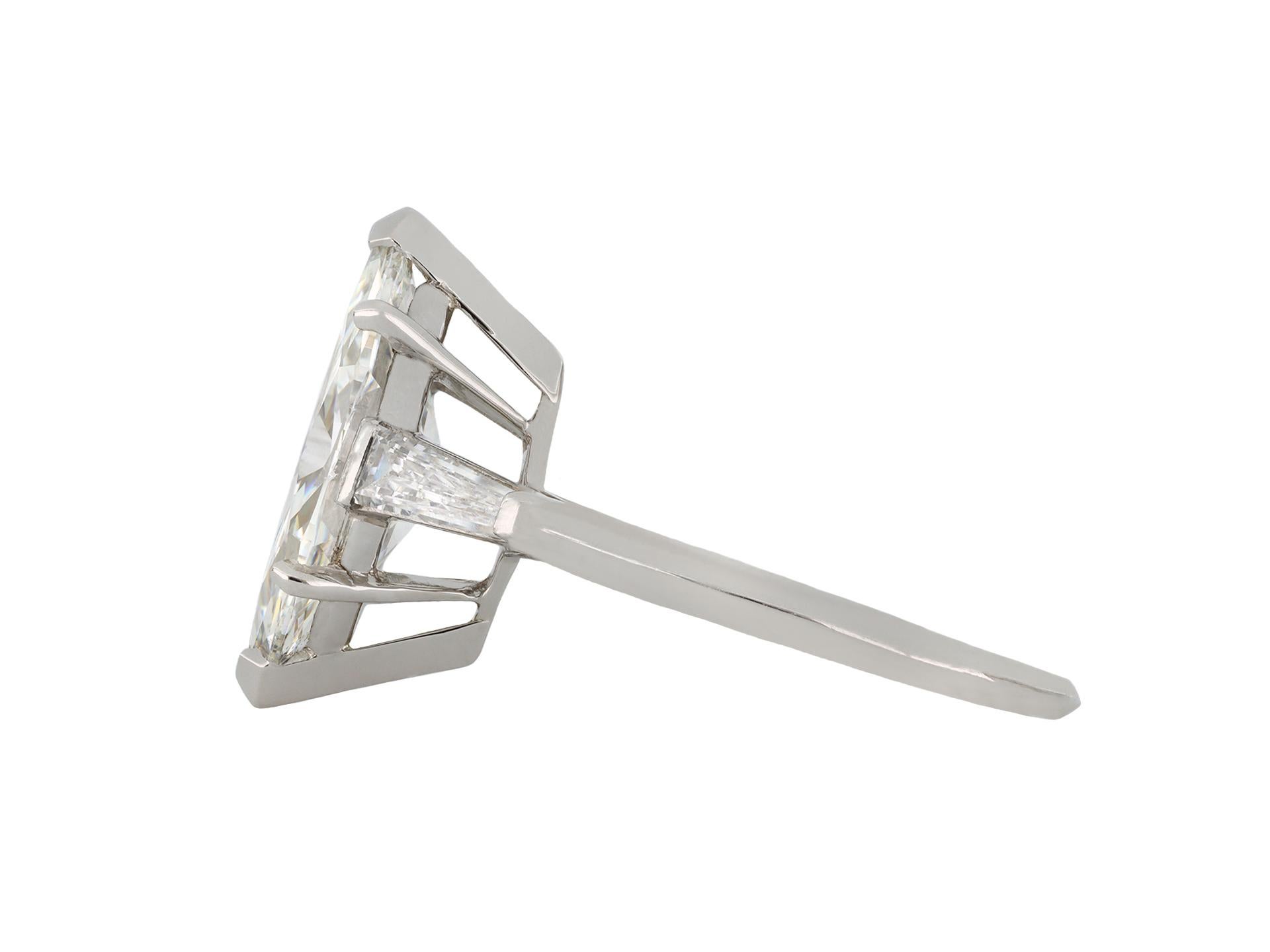 Boucheron marquise shape diamond ring. Set to centre with a marquise shape old cut diamond, H colour, SI1 clarity, with an approximate weight of 3.04 carats in an open back claw setting, flanked by two tapered baguette cut diamonds in open back half