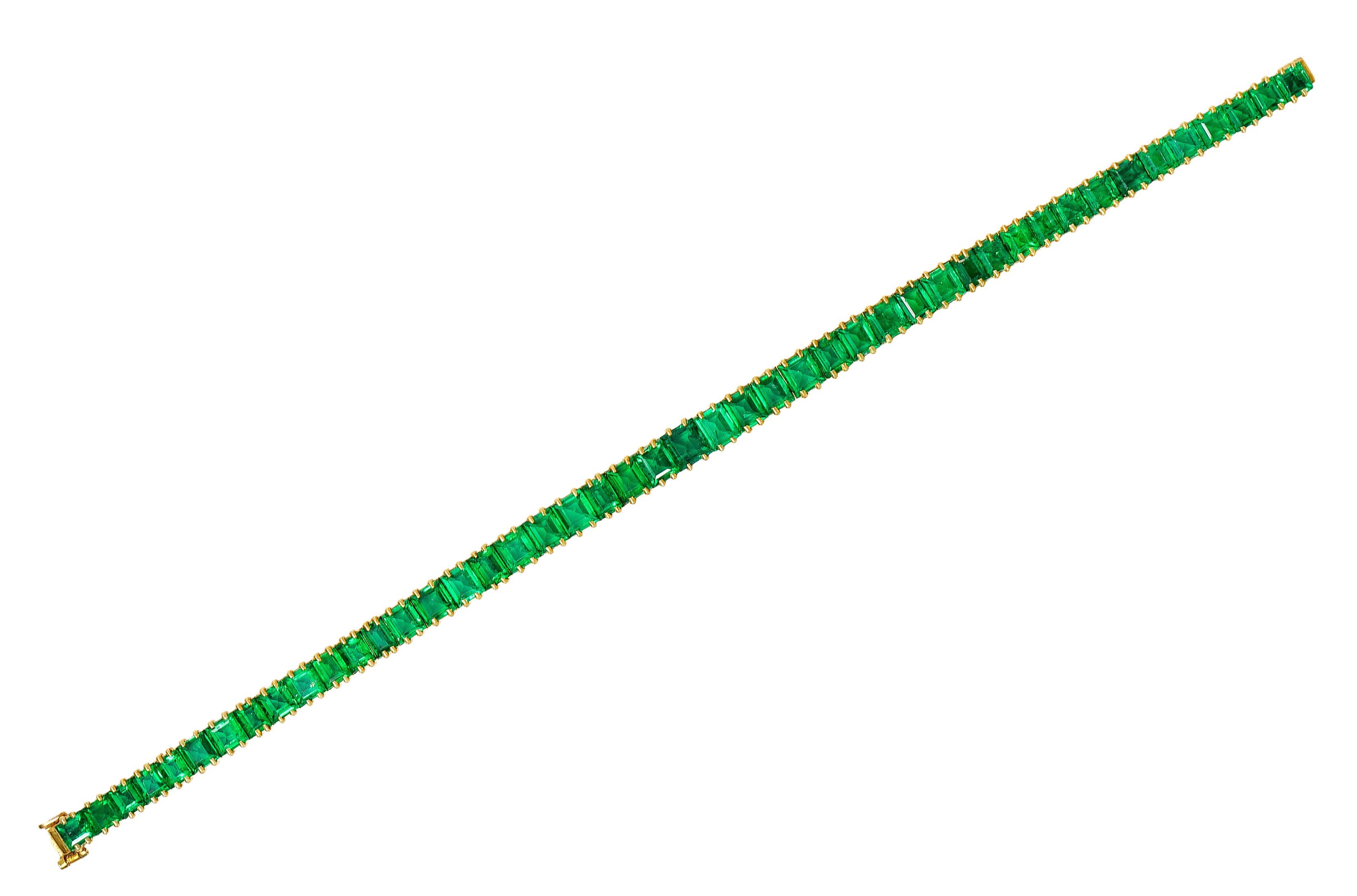 Line bracelet is comprised of basket set emerald cut emeralds - subtly graduating in size

Well matched and vividly green in color while weighing in total approximately 12.50 carats

Completed by a concealed clasp with fold-over safety

Stamped with