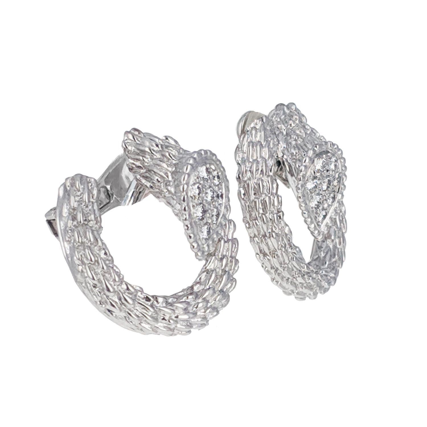 These iconic Boucheron Serpent Boheme clip earrings are set in 18 karat white gold. The heads feature 16 round brilliant cut diamonds for an estimated 0.65 carats total. They are signed Boucheron, with number A2993614, French hallmark for gold and