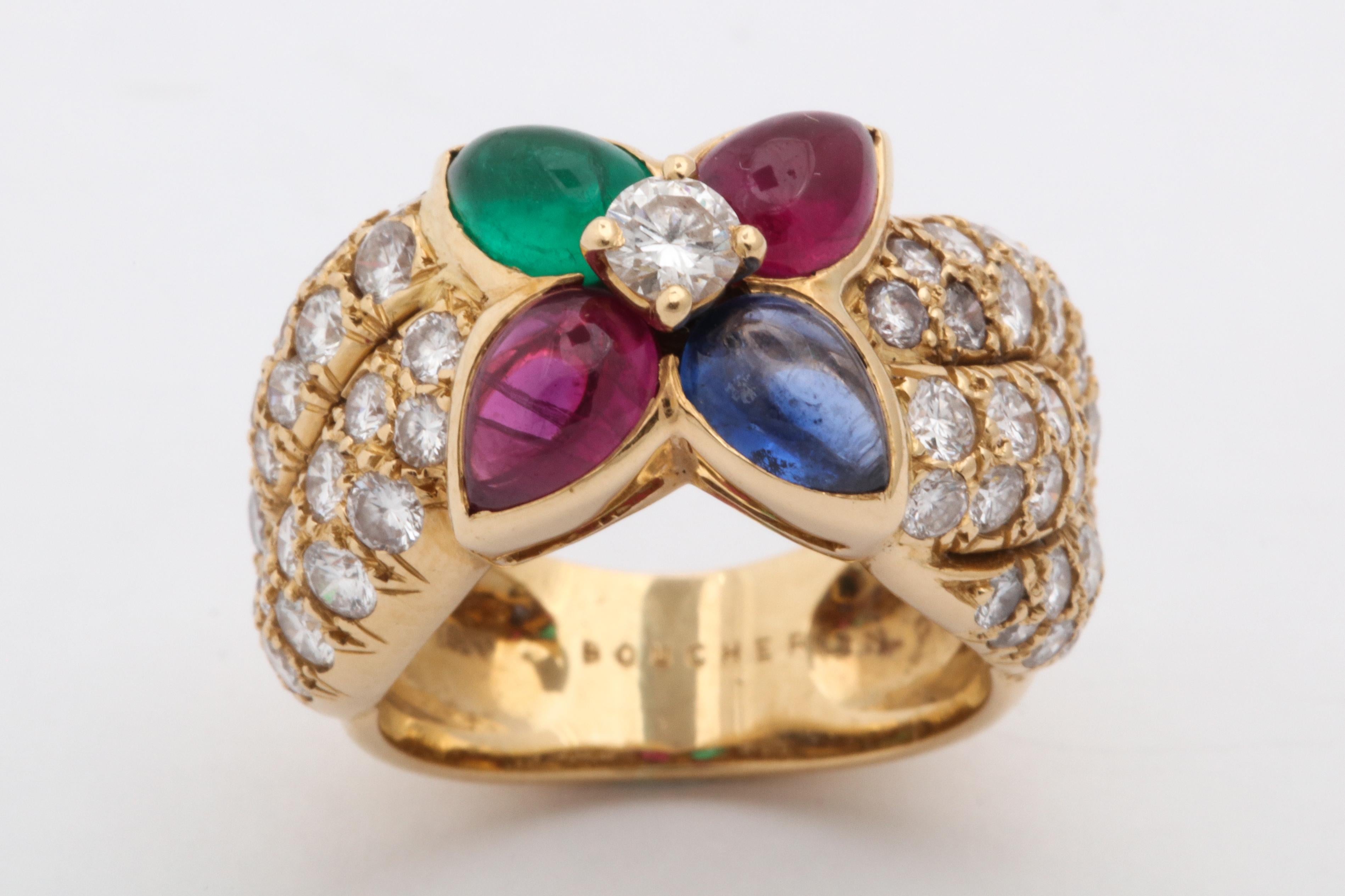 One Ladies 18kt Yellow Gold High Qualty Band Style Ring Composed Of Three Different Colored Stones,One Emerald,Two Rubies And One Sapphire All Pear Shaped Cabochon Cut. This Ring Is Further Embellished With Numerous Diamonds Weighing Approximately