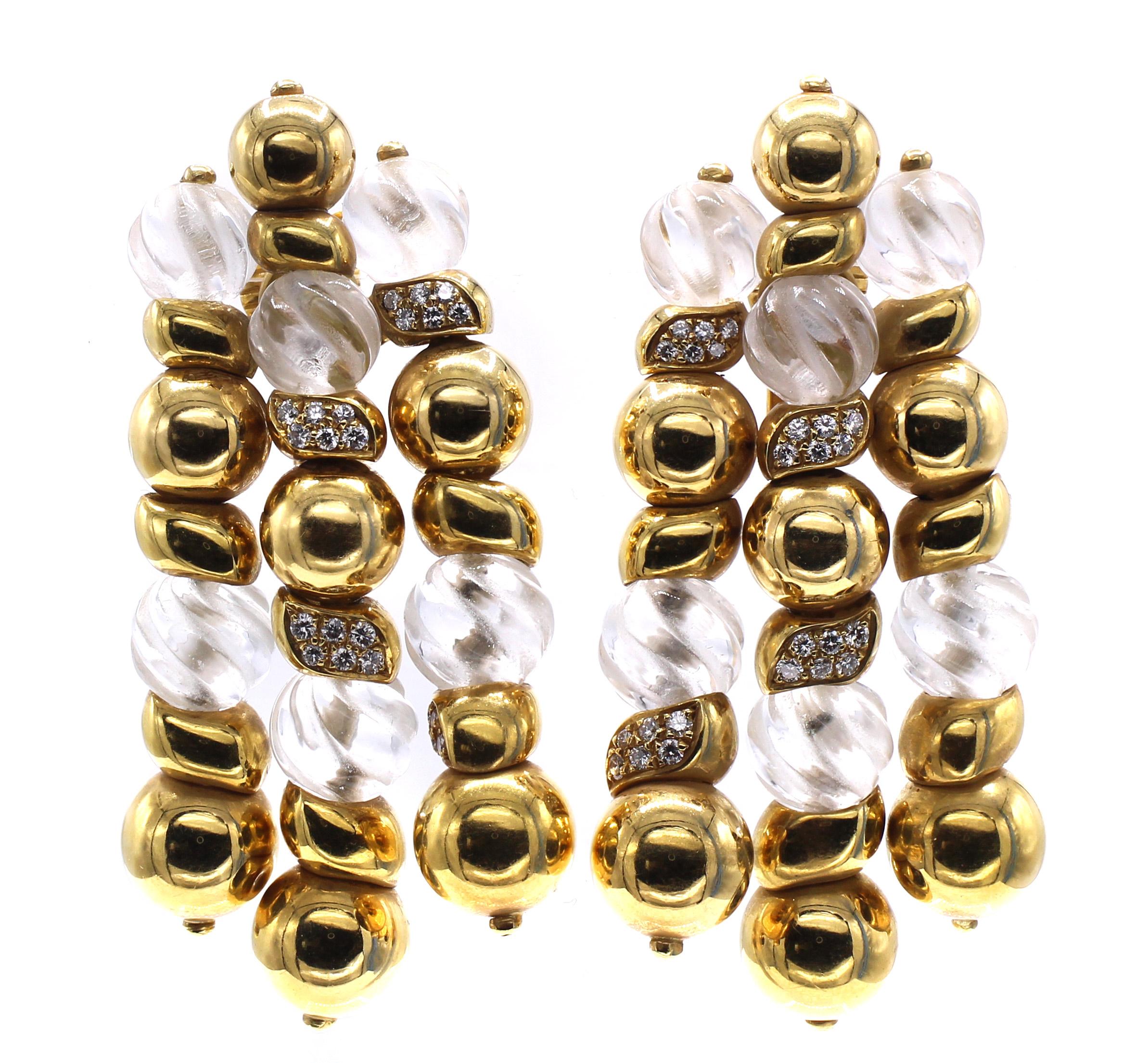 Beautifully designed and masterfully handcrafted these stunning earrings were created in the 1980s by the renown Parisian jeweler Boucheron. Round spheres of 18 karat yellow gold are spaced by round crystal spheres etched with a wavy design and