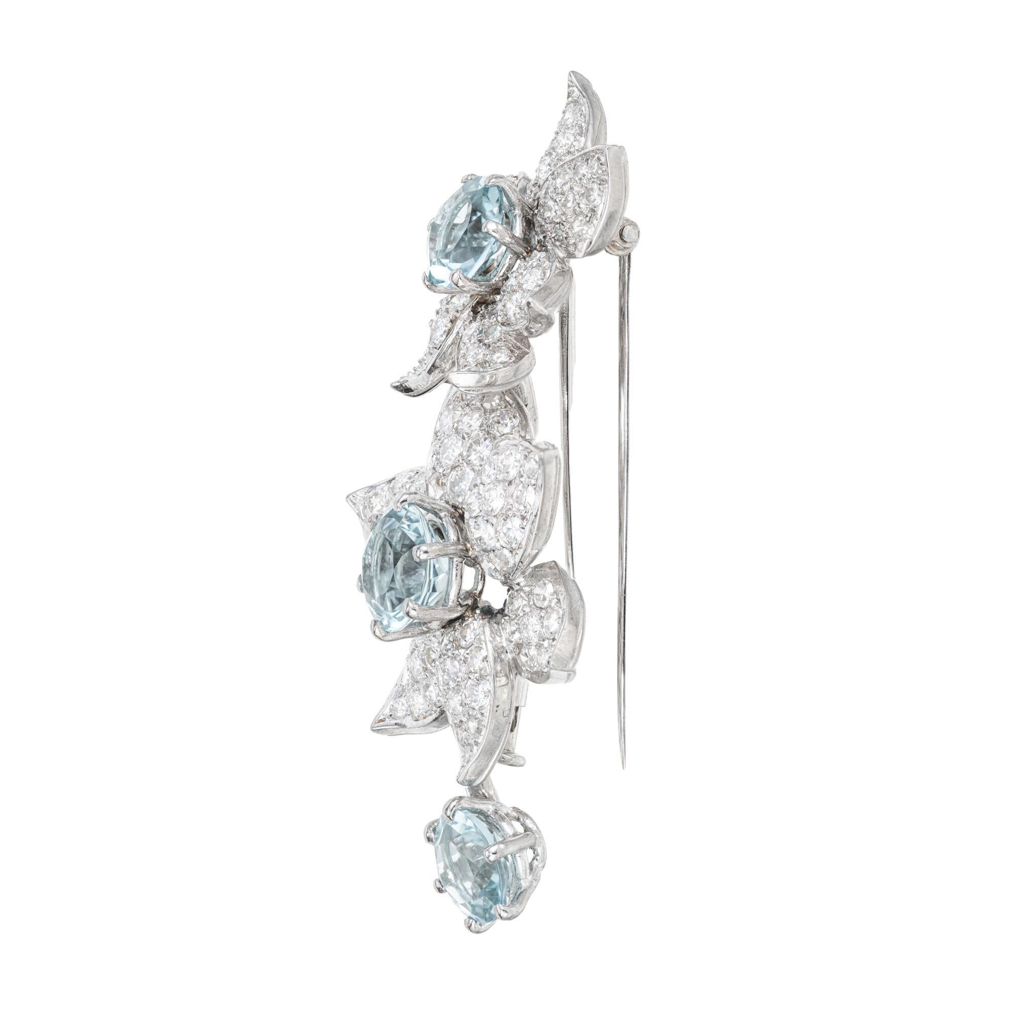 1940's Authentic Boucheron Paris diamond platinum flower brooch. 3 round aquamarines totaling 3.98cts, each with a flower design pave diamond set halo. Double pin stem for stability. 

Boucheron is a French premier luxury jewelry and watch house,