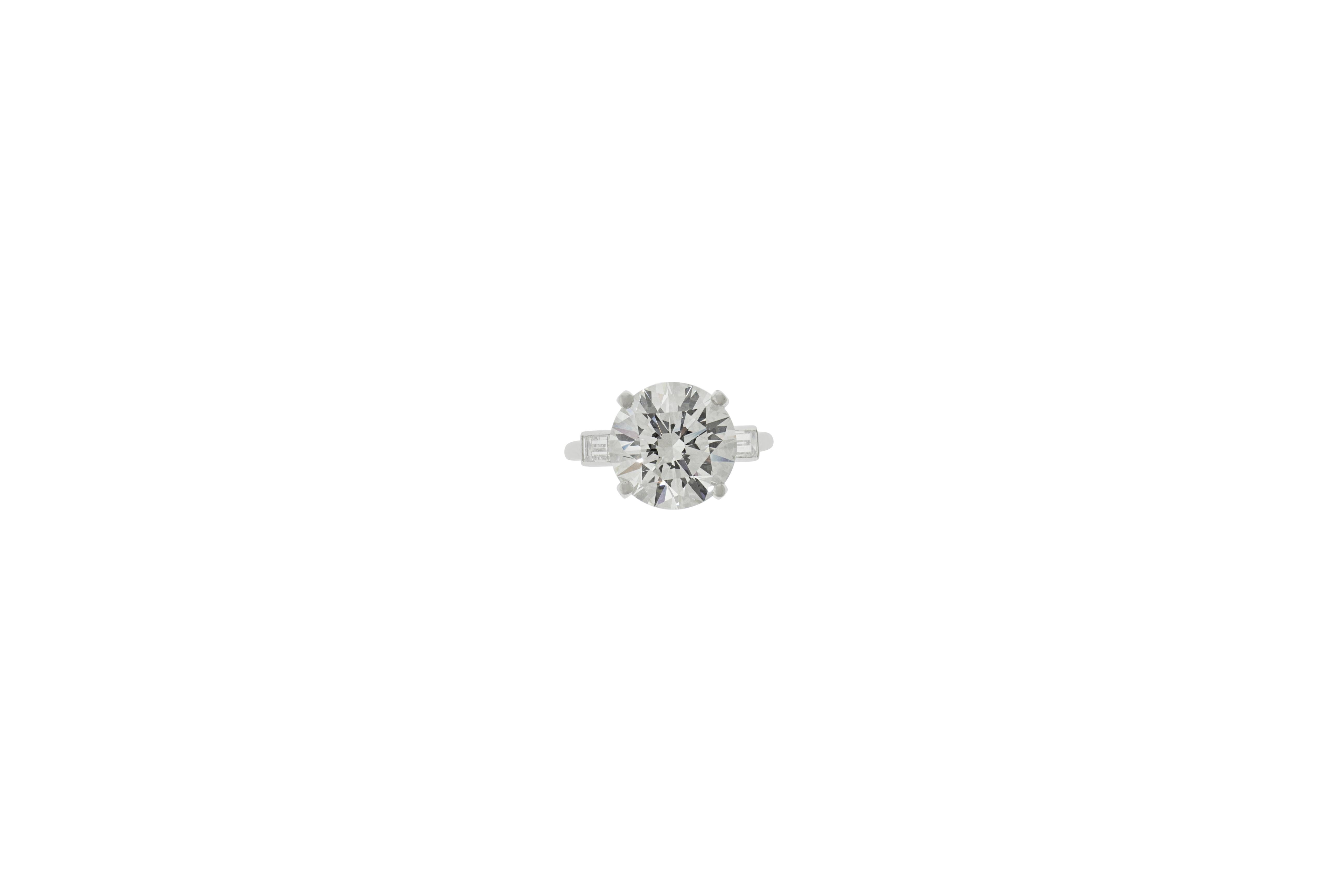 4.76 carat round brilliant cut diamond engagement ring flanked on either side by a baguette cut stone. Signed Boucheron Paris. Size 6. GIA certificate No. 2165796208 F VS2. 


Viewings available in our NYC showroom by appointment.