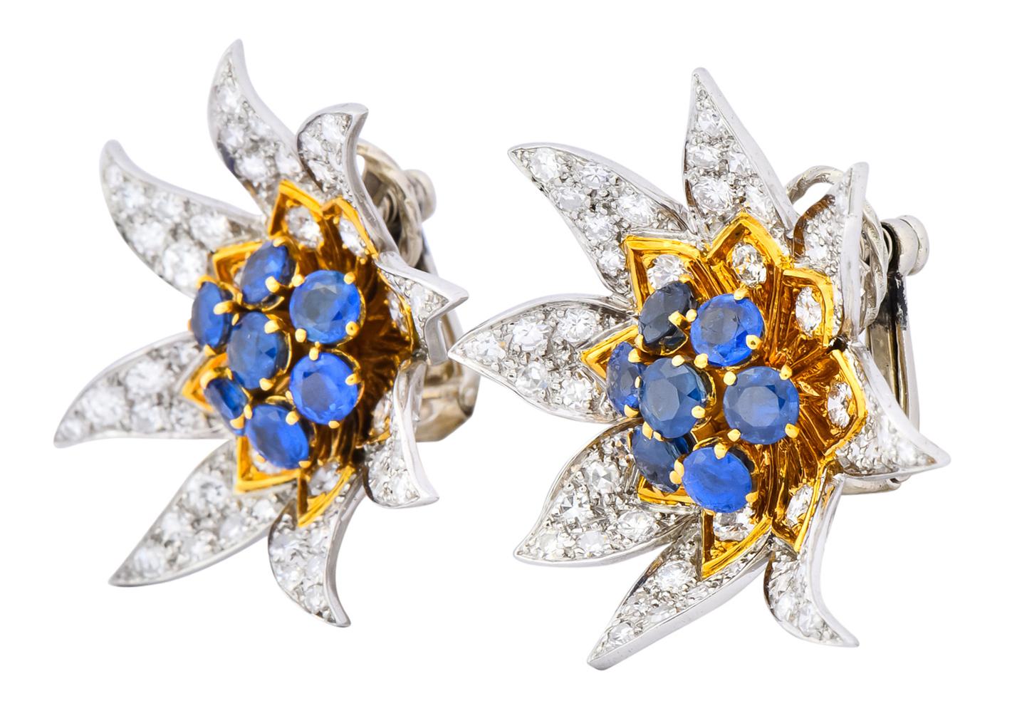 Each designed as a flower with petals featuring pavé set round brilliant cut  diamonds weighing approximately 2.72 carats total, E-F color and VVS-VS clarity

Polished gold petal accents and bright vivid blue sapphires in bead set gold