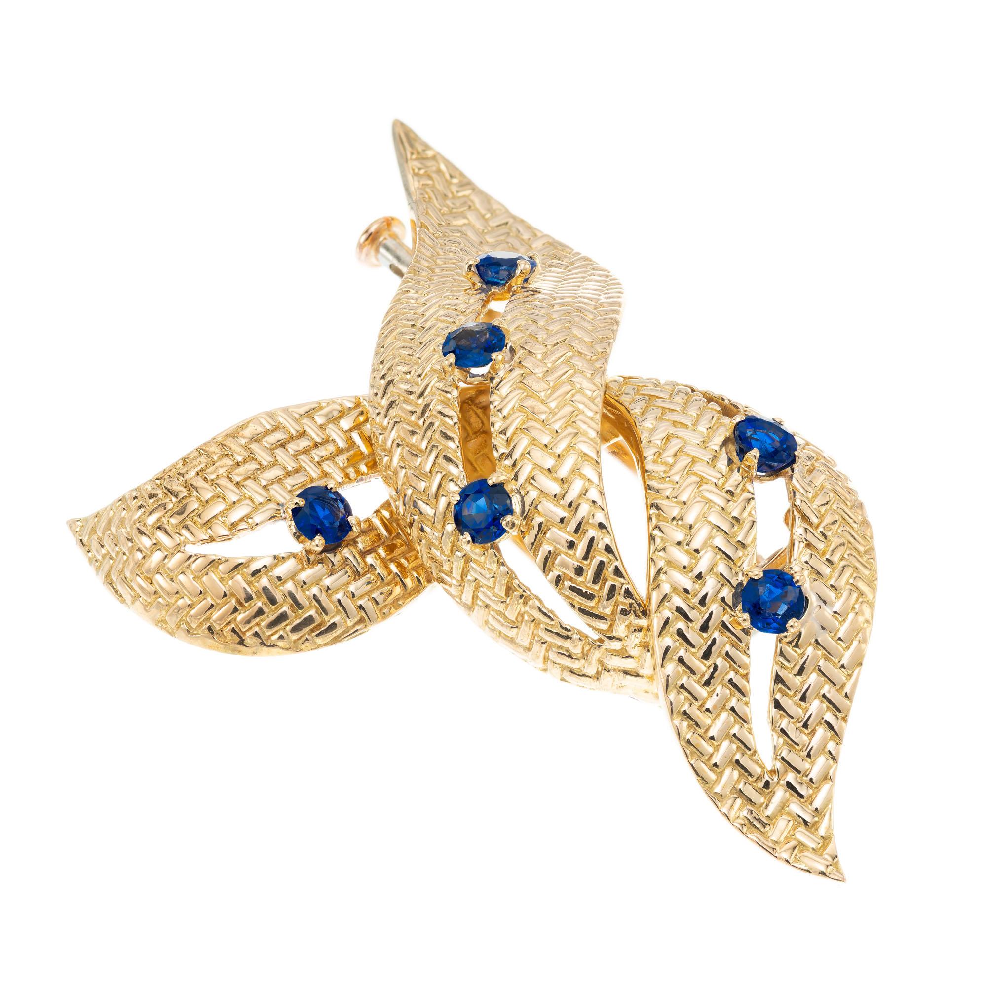 Mid-Century Boucheron Paris 1950's 18k yellow gold swirl pin with a 6 round blue sapphires.

6 round blue sapphires, VS-SI approx. .70cts
18k yellow gold 
Stamped: Boucheron Paris 
13.2 grams
Top to bottom: 42.6mm or 1 11/16 Inch
Width: 33.2mm or