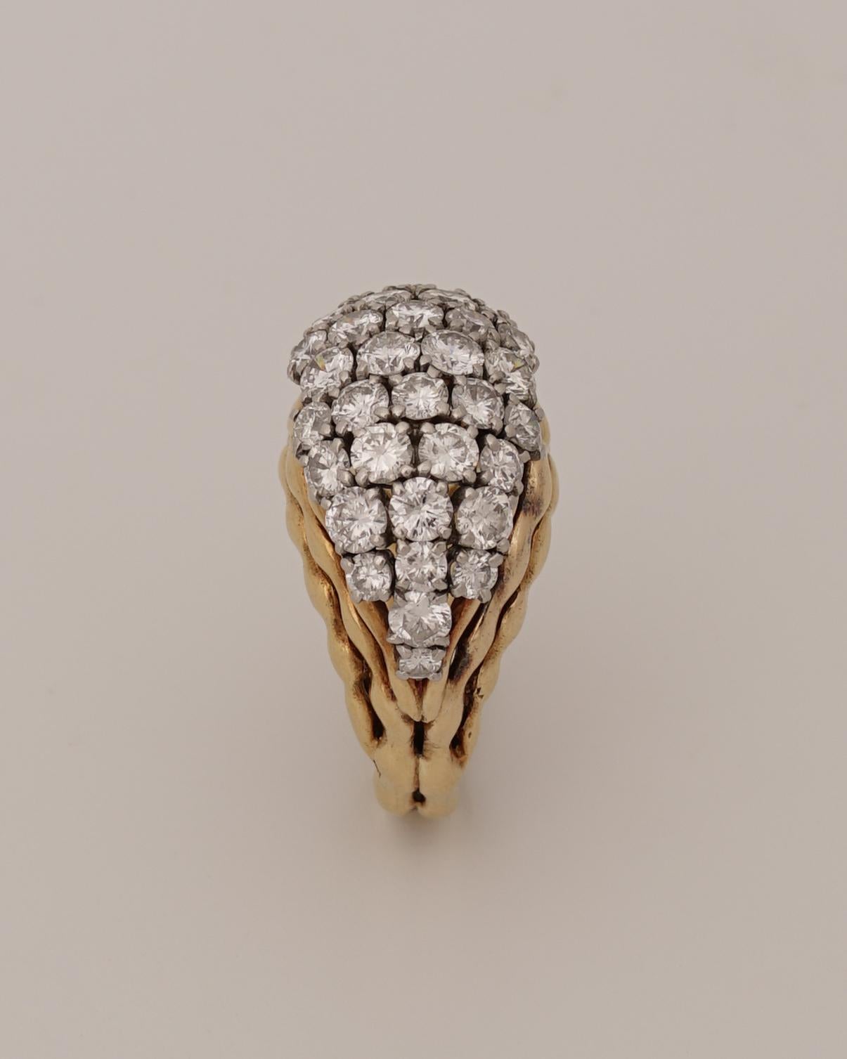 Boucheron, Paris
Stunning Diamond and 18k Gold ring, Circa 1970
Of Wave design, the ring is heavy in hand and wears a incredible diamond architectural setting.
The bombé form is set in platinum with 38 brilliant-cut diamonds (G-VVS) between gold