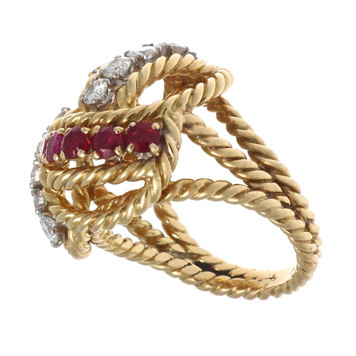 Famous throughout the world for its bold, free style, Boucheron has remained in the top tier of jewelry houses by offering ever more creative jewelry. Featuring a swirl of diamonds and rubies set between waves of 18k rope motif yellow gold. Signed