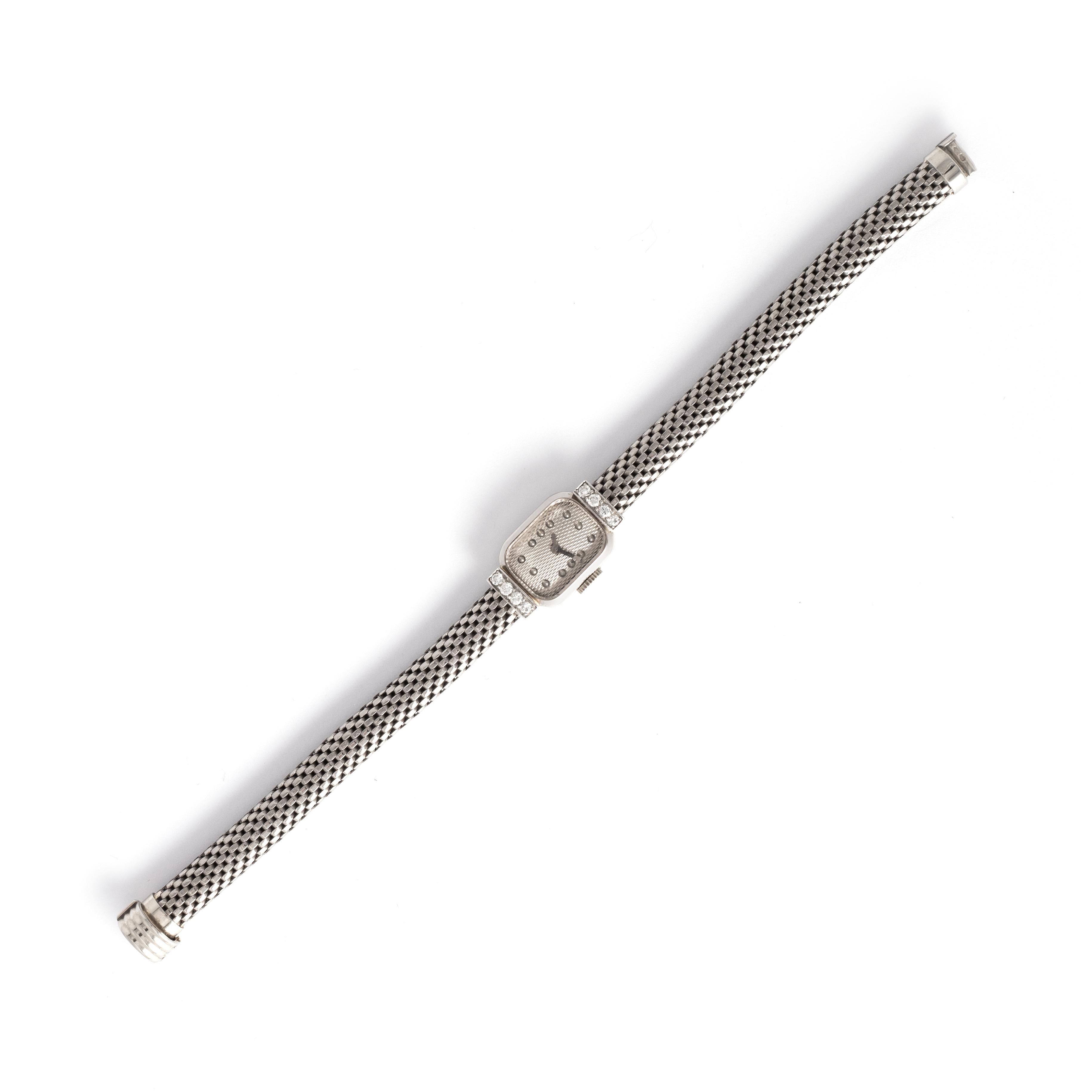 Boucheron Paris Diamond 18K White Gold Wristwatch
Set with 8 diamonds.
French marks. Circa 1950.
Reference number: 72608.
Case dimensions: 2.20 x 1.30 centimeters.
Length: 18.00 centimeters.
Width bracelet: approximately 0.60 centimeters.
Weight: