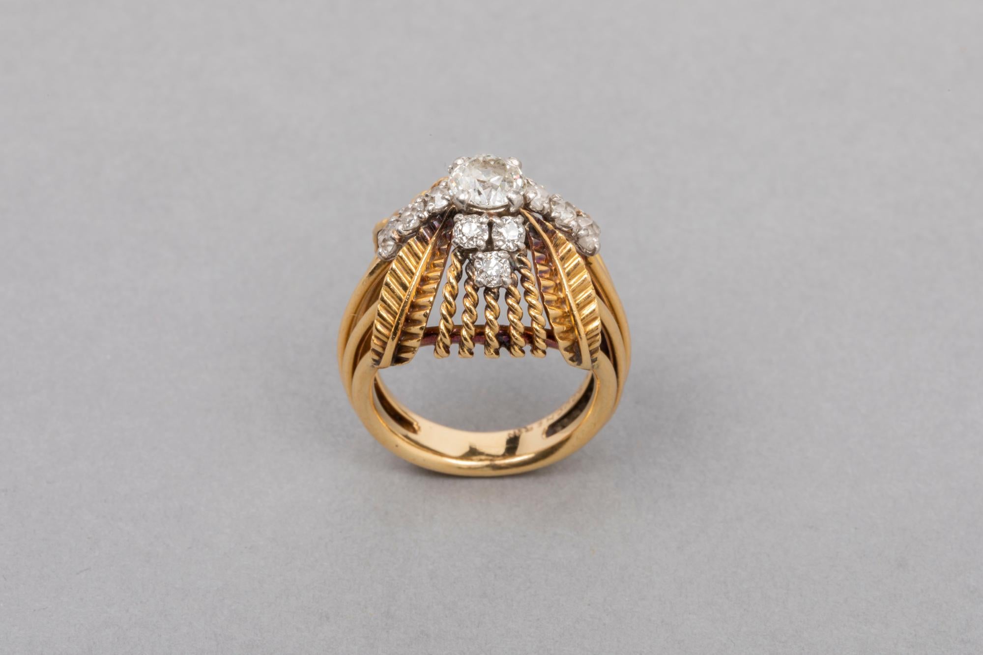 Very beautiful ring, made by Boucheron Paris circa 1960. 
Mounted in yellow gold 18k and Platinum( eagle Mark and dog mark) Signed Boucheron. 
With original boxe.
The central round diamond weight 0.55 estimate, 1 carat for the total. 
The cut is Old