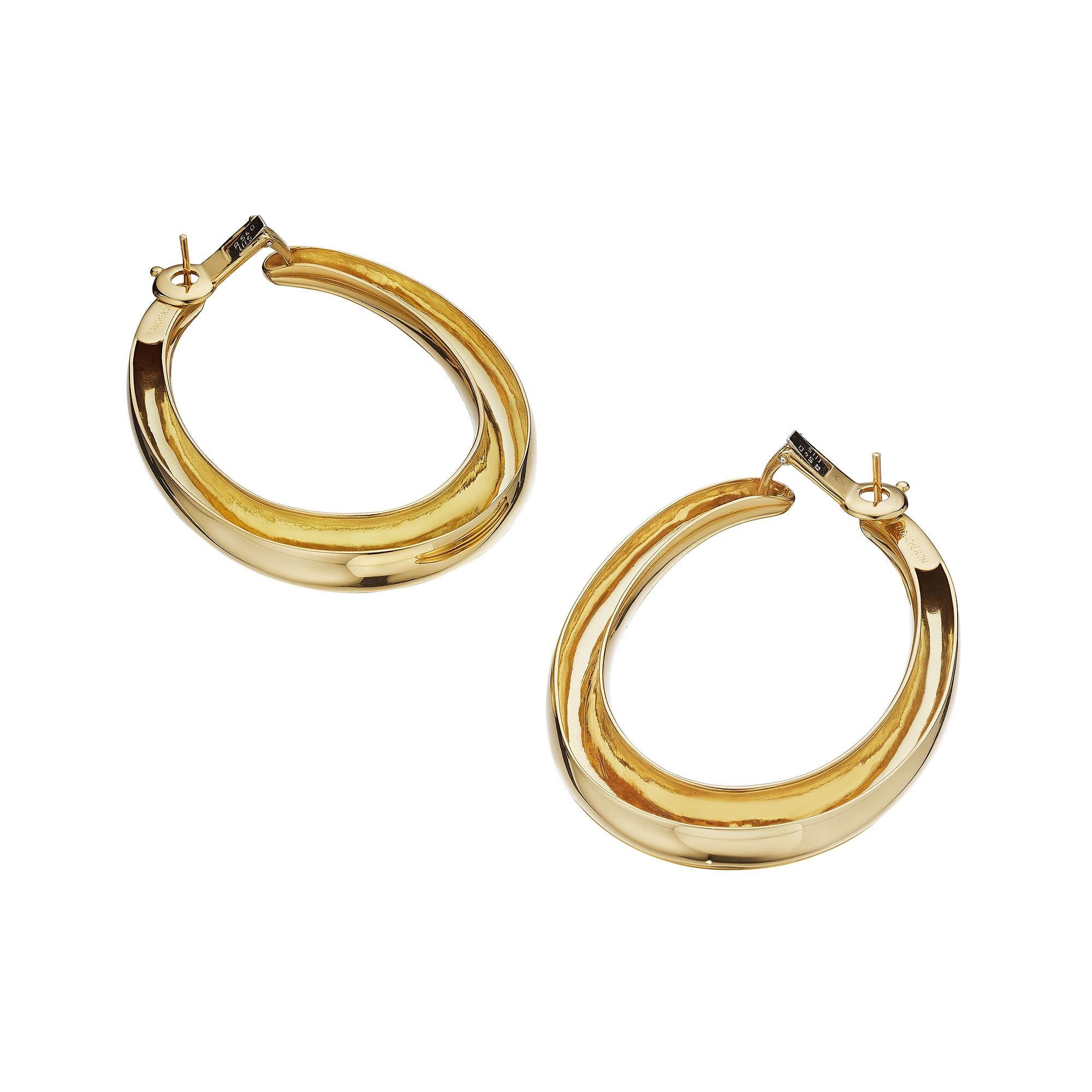 These Boucheron Paris modernist earrings will throw you for a loop.  With their large scale oval drop yellow gold tubular loops, these stylish hoop earrings are a collectible wardrobe statement piece.  Signed Boucheron.  Circa 1975-80.  Post with