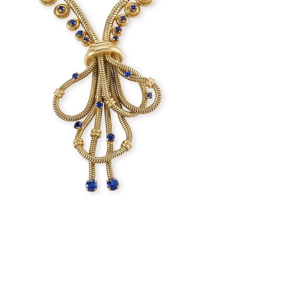 A French Retro 18 karat gold necklace with sapphires by Boucheron. The necklace has 57 round-cut sapphires with an approximate total weight of 2.25 carats. The necklace is designed in a modified zipper motif of snake chain and round-set sapphires