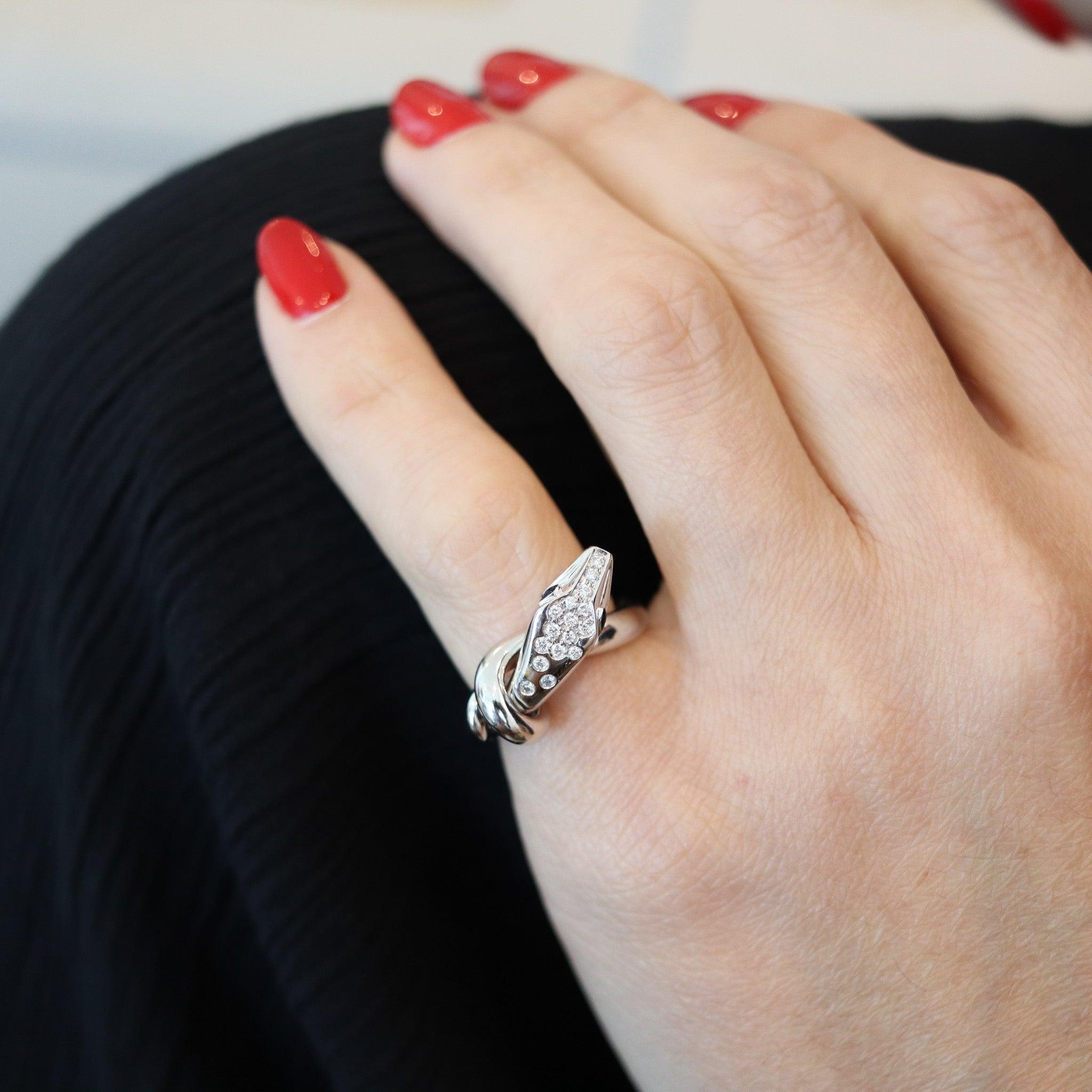 Serpent Kaa ring designed by Boucheron.

This is a beautiful contemporary twisted serpent ring, created by the French jewelry house of Boucheron. The Serpent-Kaa ring is a classic and has been carefully crafted in solid white gold of 18 karats with
