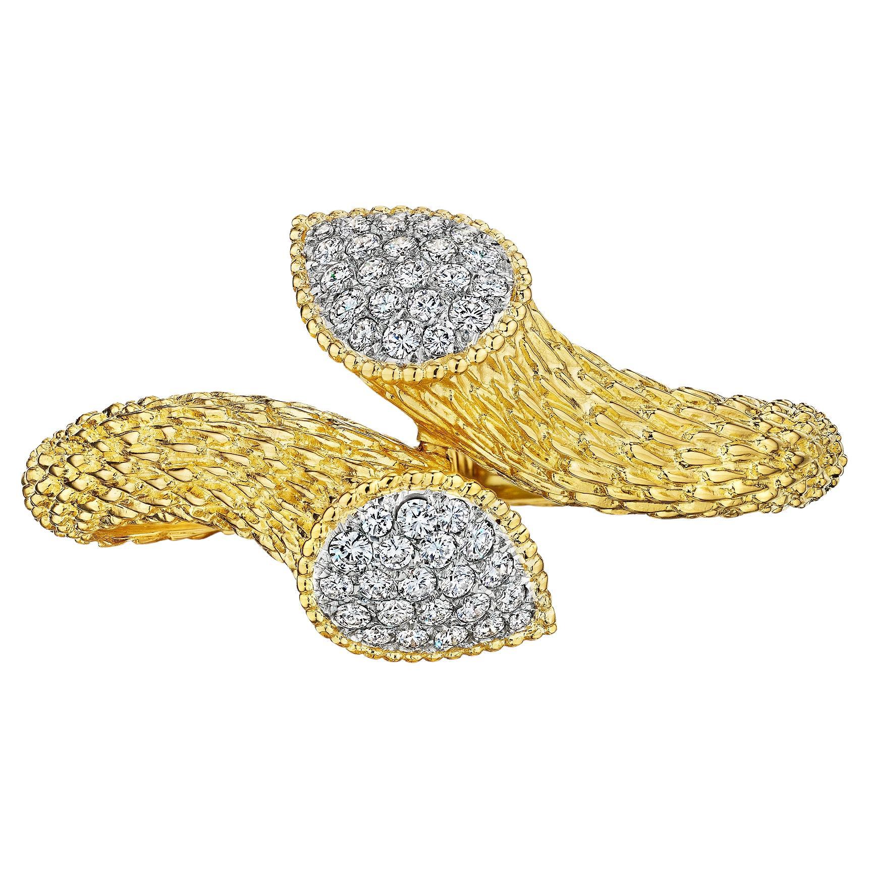 Slither and slide 24/7 with this iconic Boucheron Paris vintage Serpent Boheme diamond gold hinged platinum and 18 karat yellow gold cuff bracelet.  With two diamond heads and hand engraved serpent body scales, this stylized snake bracelet is filled